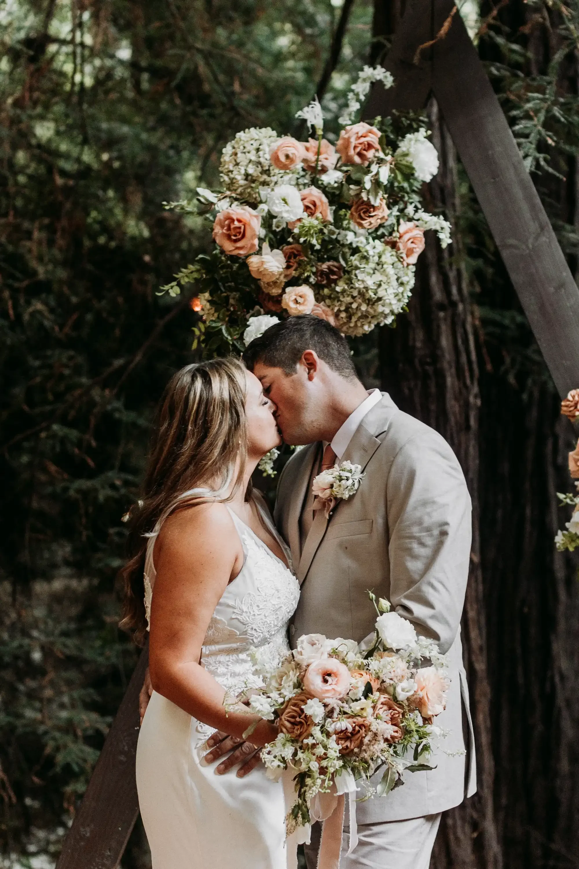 April and Trey Big Sur Elopement Kiss Under Arbor