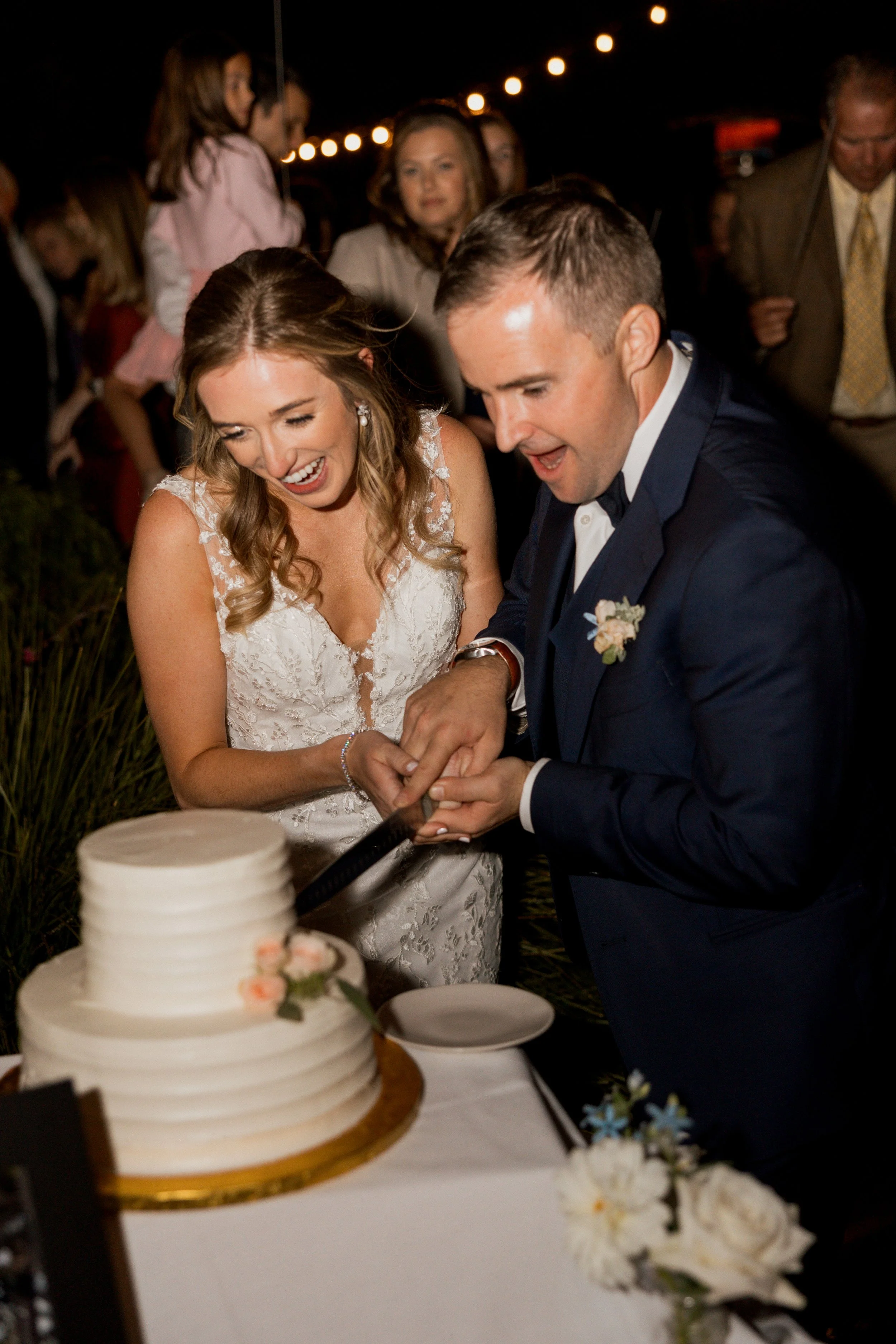 Bride and groom portraits cutting wedding cake at a Pebble Beach wedding by Love in Bloom Events