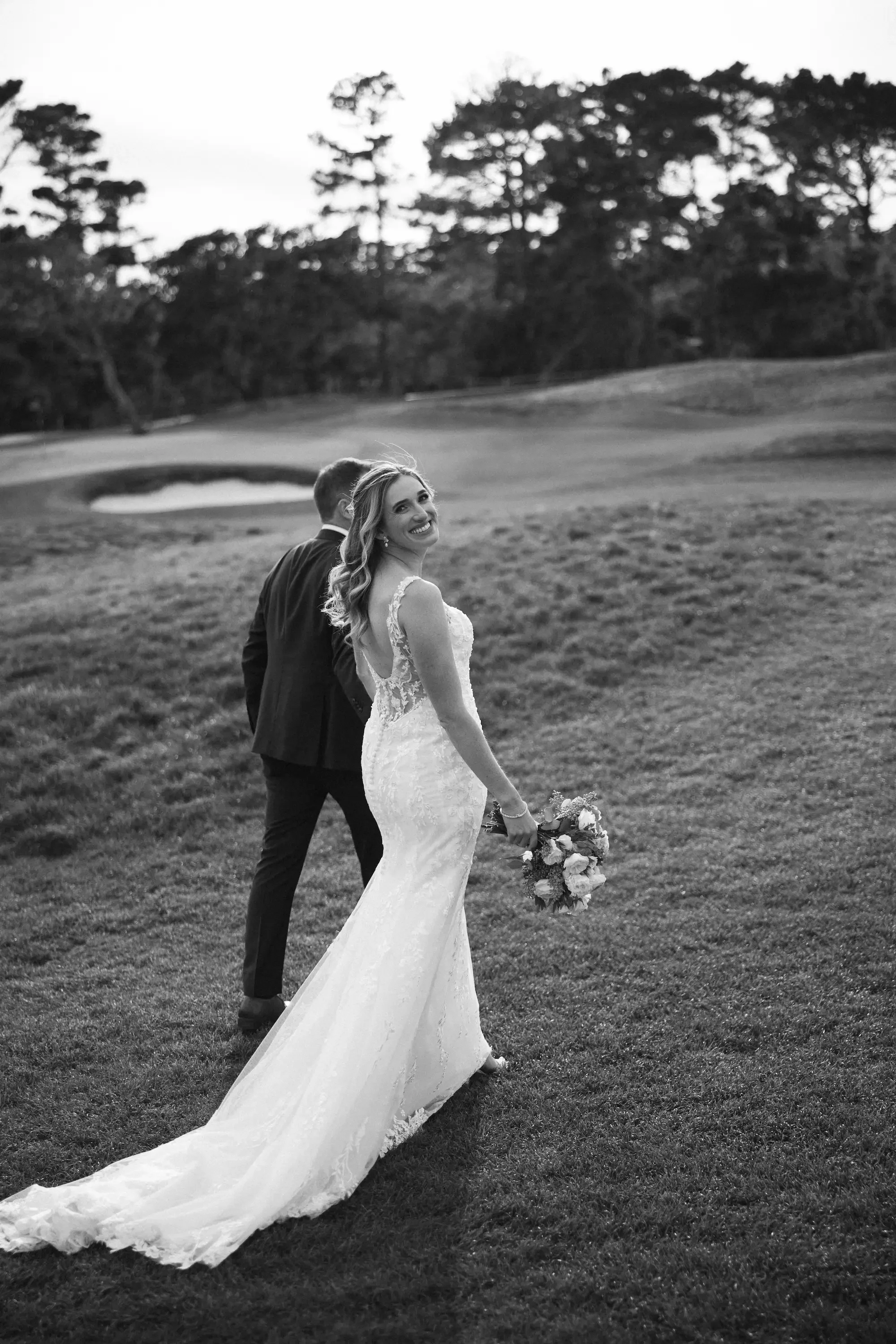 Robert and Tierney walking on Pebble Beach Golf Course after using Love in Bloom for Partial Planning Wedding