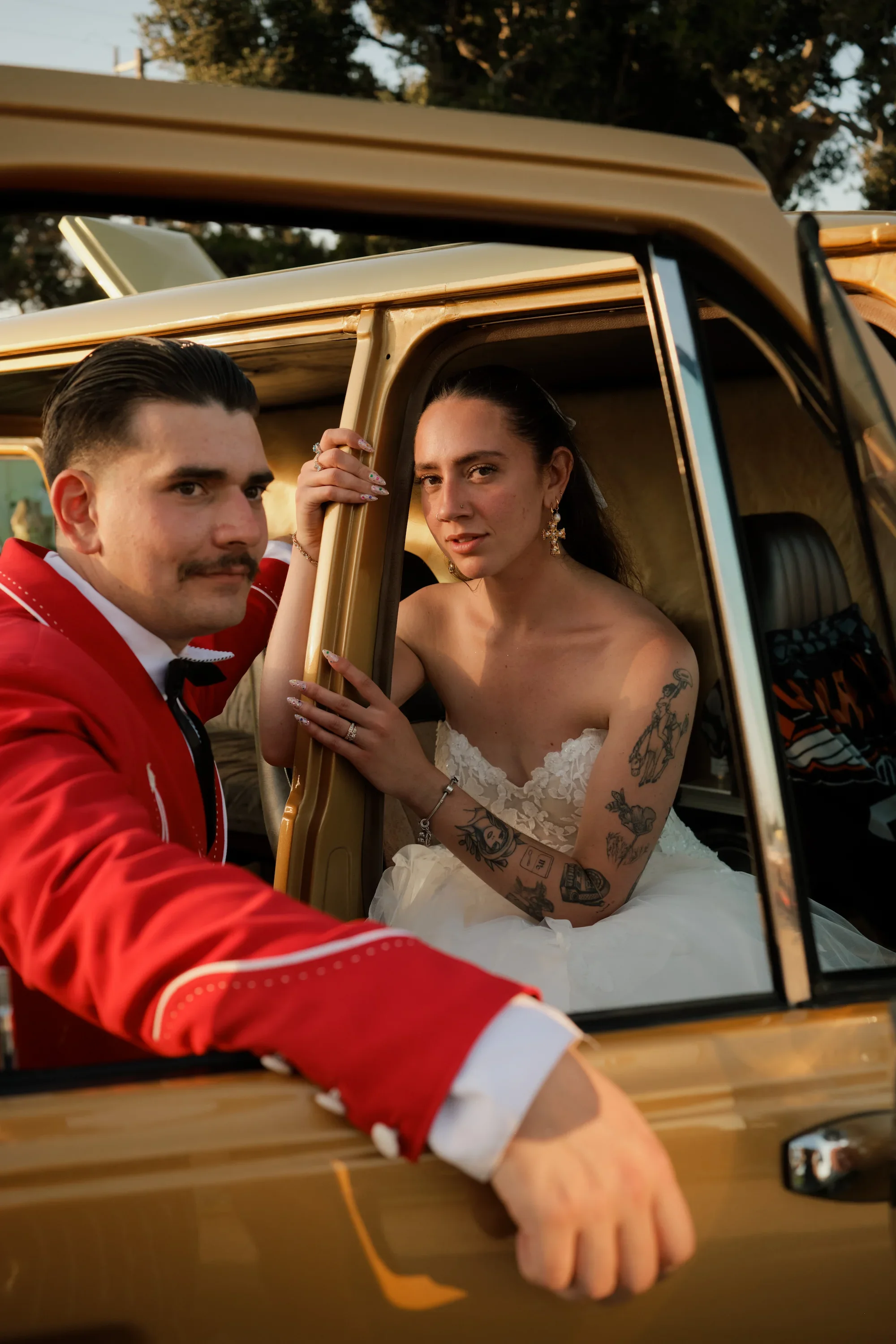 Danielle and Rhett posing in a car during golden hour with Partial Planning Services
