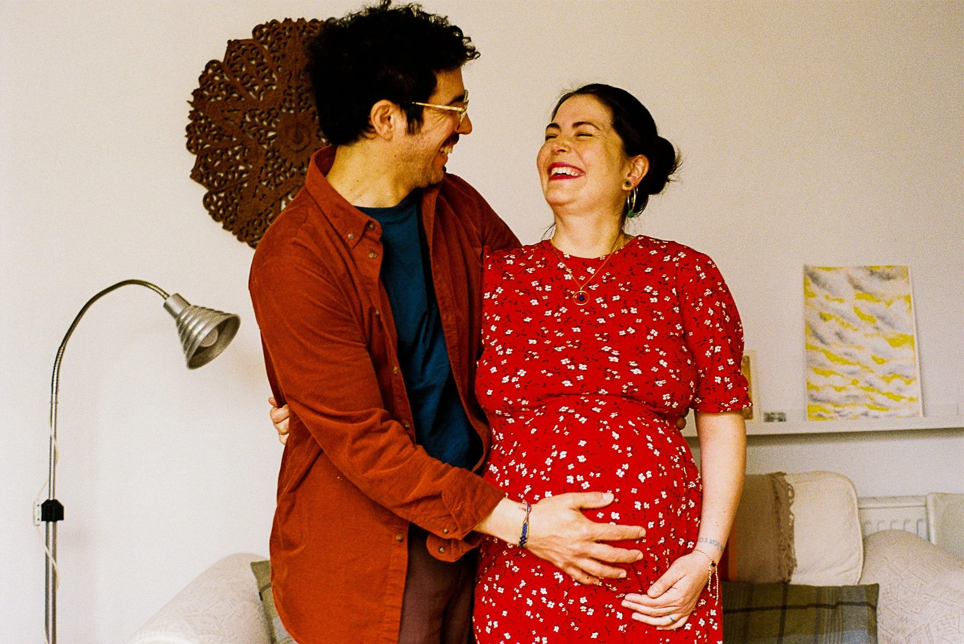 Parents wearing red tones to show colour coordination for a 35mm film photo session.