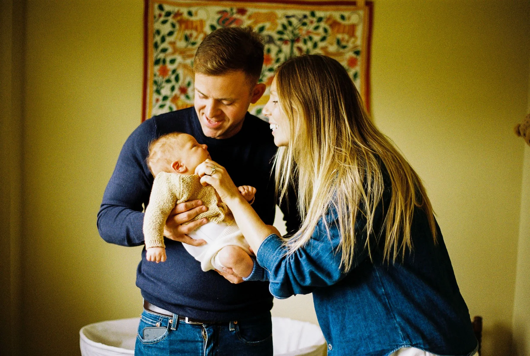 In-home family portrait of three in their Dublin living room, captured on 35mm film.