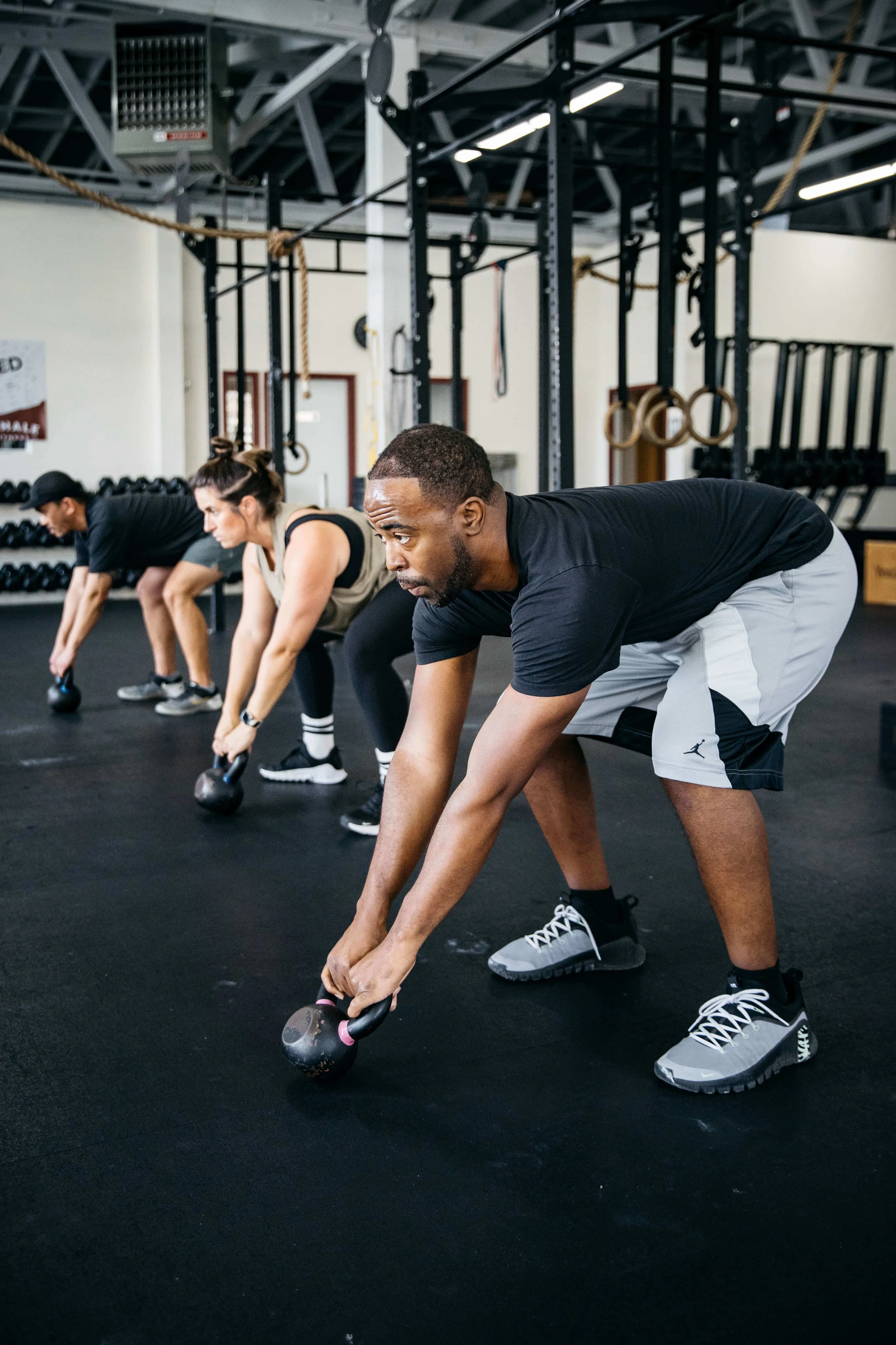 Crossfit athletes do kettlebells swings, shot for Exhale Gym in Richmond, CA.