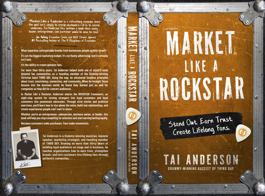 The front cover of a book titled "Market Like a Rockstar" by Tai Anderson, featuring an orange background with a black chalkboard section that says "Stand Out. Earn Trust. Create Lifelong Fans". The spine shows the title and author's name, and there's a quote about standing out like a Rockstar.