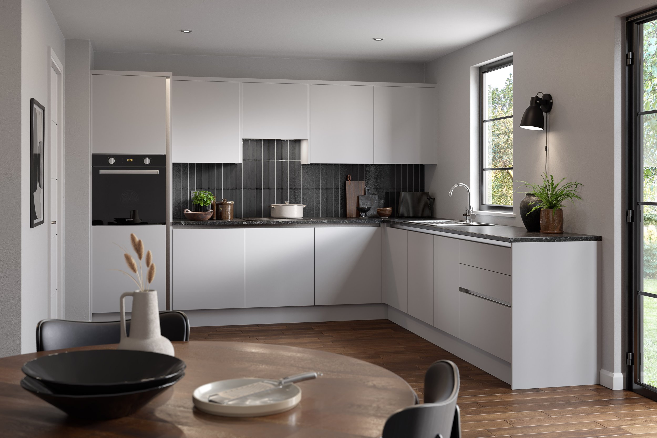 Modern kitchen with white cabinets, black countertop, black backsplash, stainless steel appliances, and large windows letting in natural light.