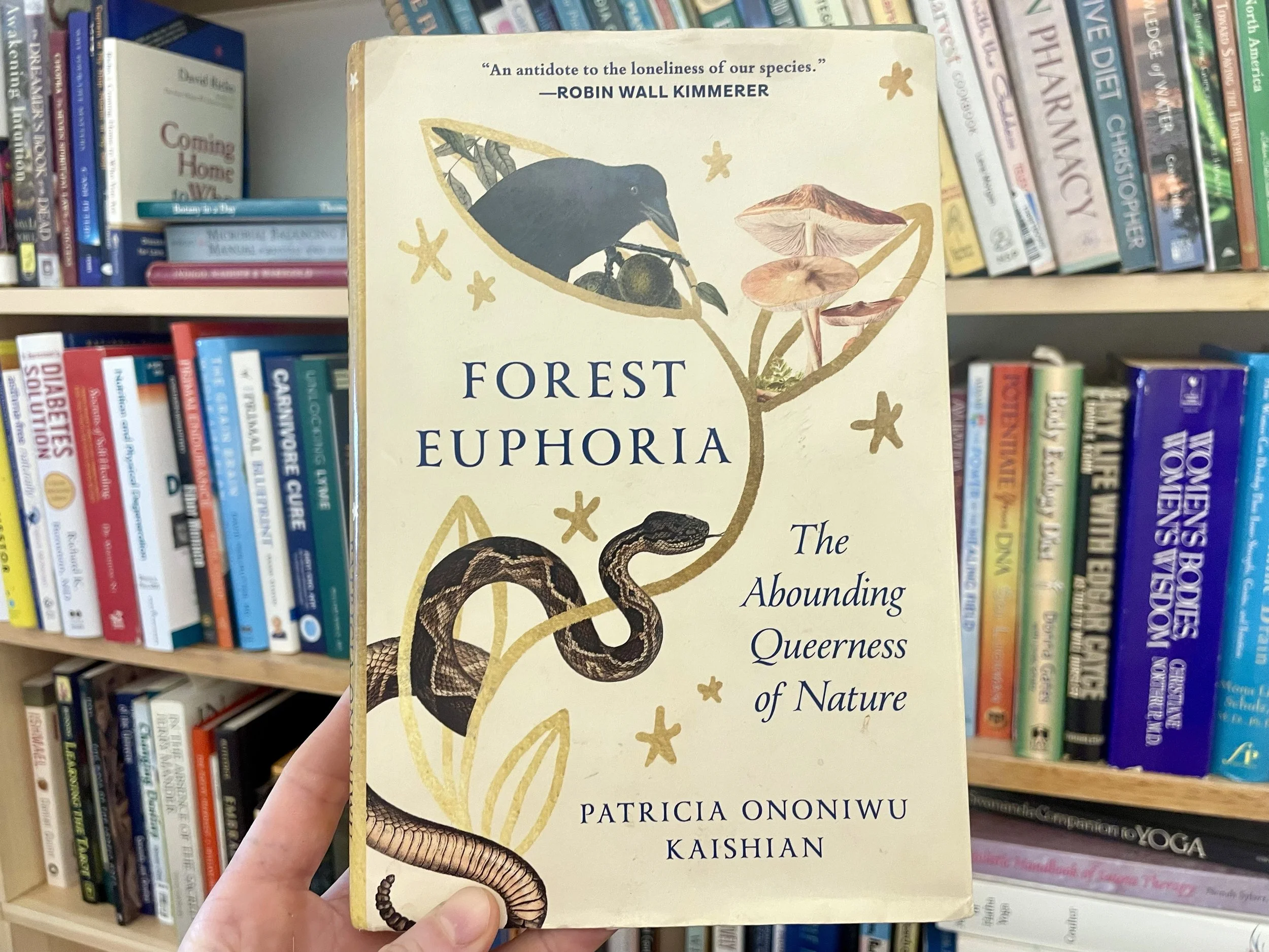 Book titled "Forest Euphoria: The Abounding Queerness of Nature" by Patricia Ononiwu Kaishian, with illustrations of a bird, a snake, mushrooms, and leaves on the cover.