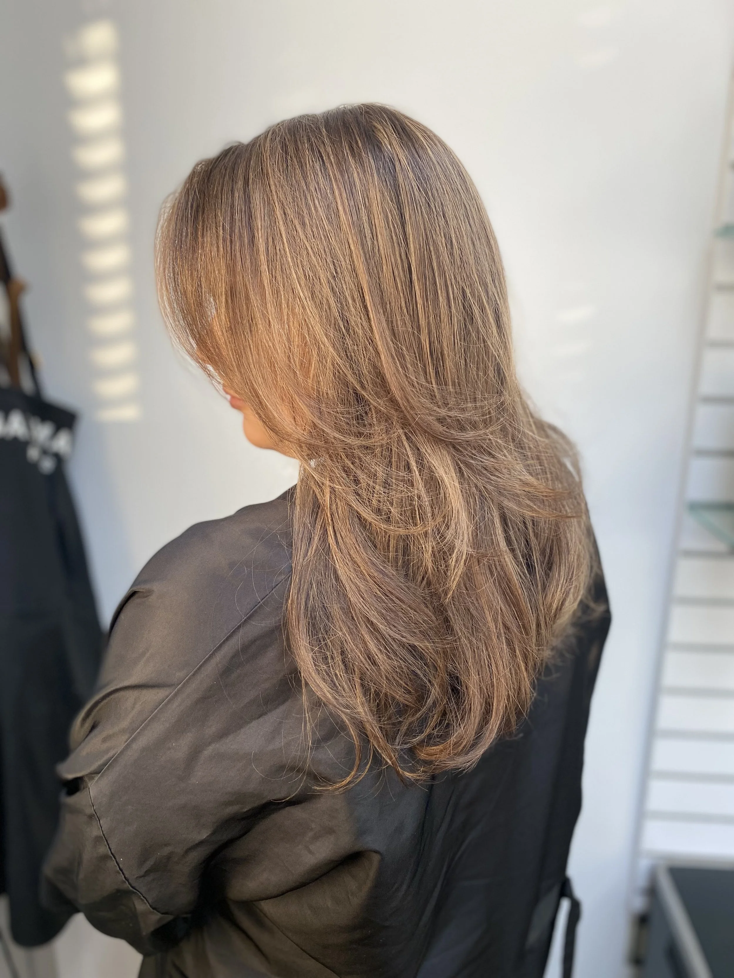 Adding a little caramel highlighting to a brunette can be a fabulous way to accentuate the amber notes in dark eyes to brighten and invigorate.