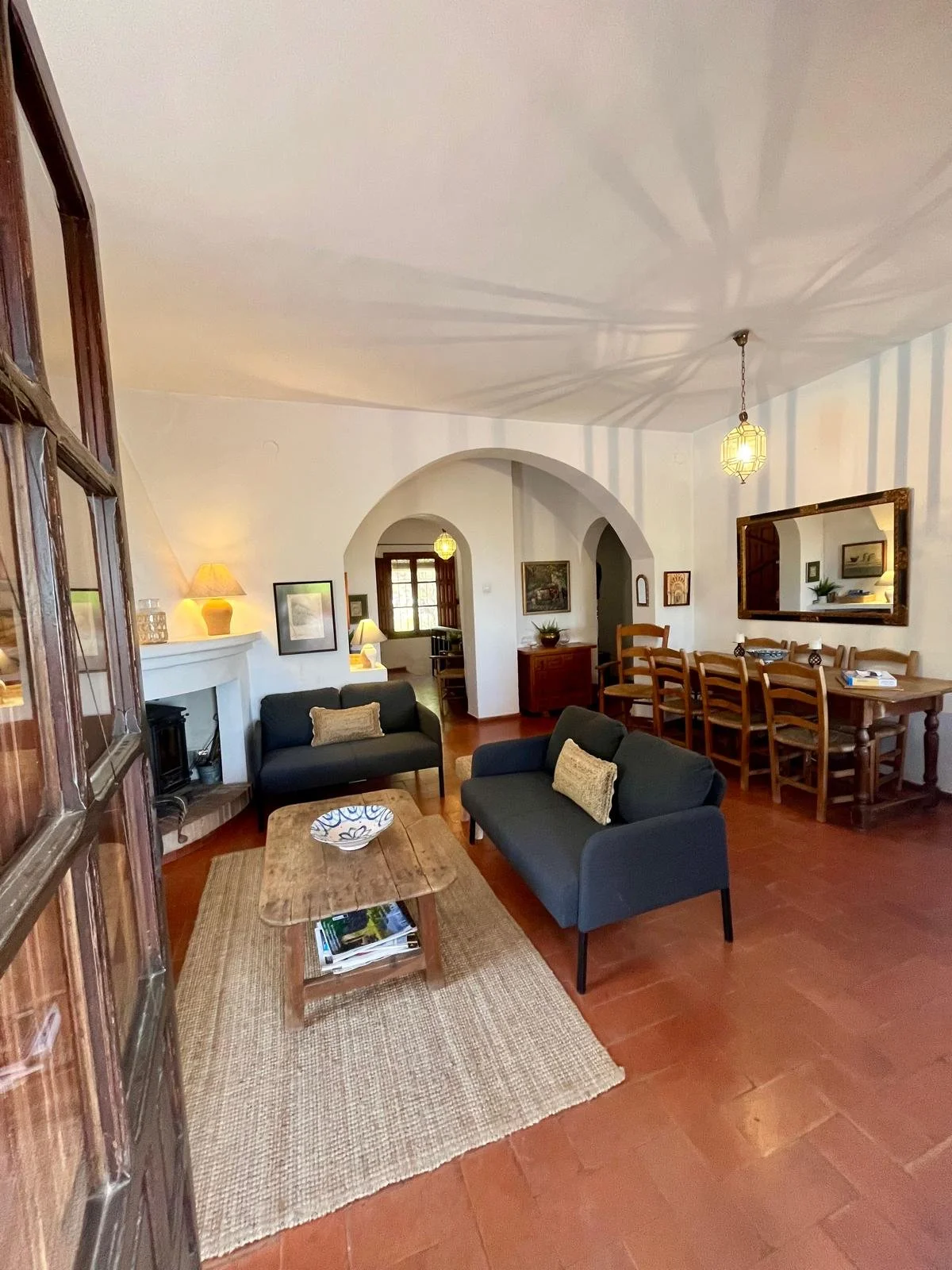 The sitting room with arch way on the right through to the kitchen.