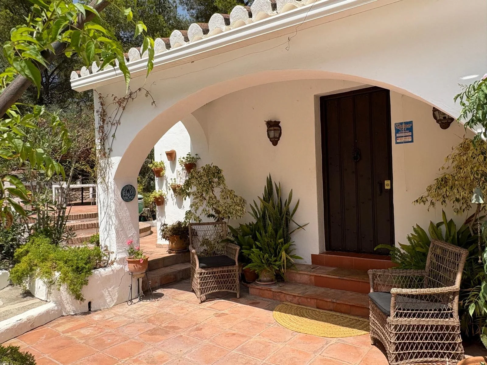 View of the porch showing the arch to the left to the barbecue terrace.