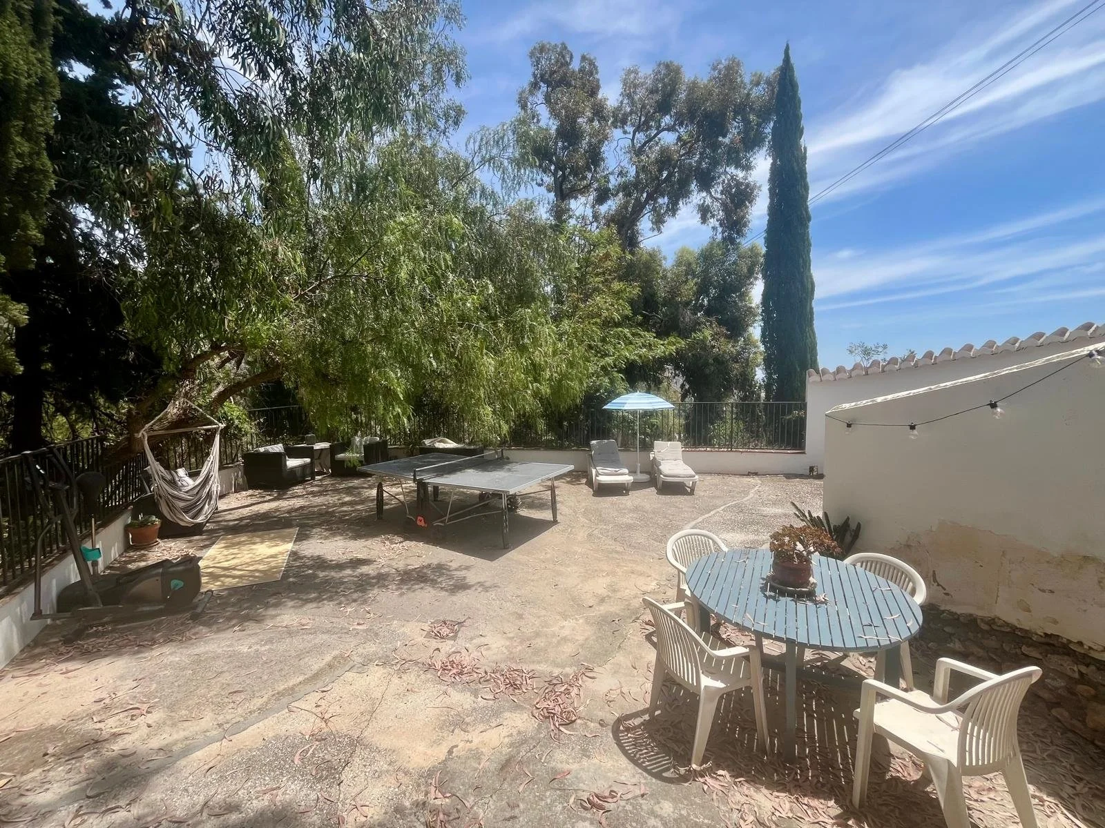 There is comfy seating next to the table tennis table also 2 loungers to catch the last off the day's sun, bench storage with yoga mats and boxing equipment, a hanging chair (with a sea view) and a separate eating area.