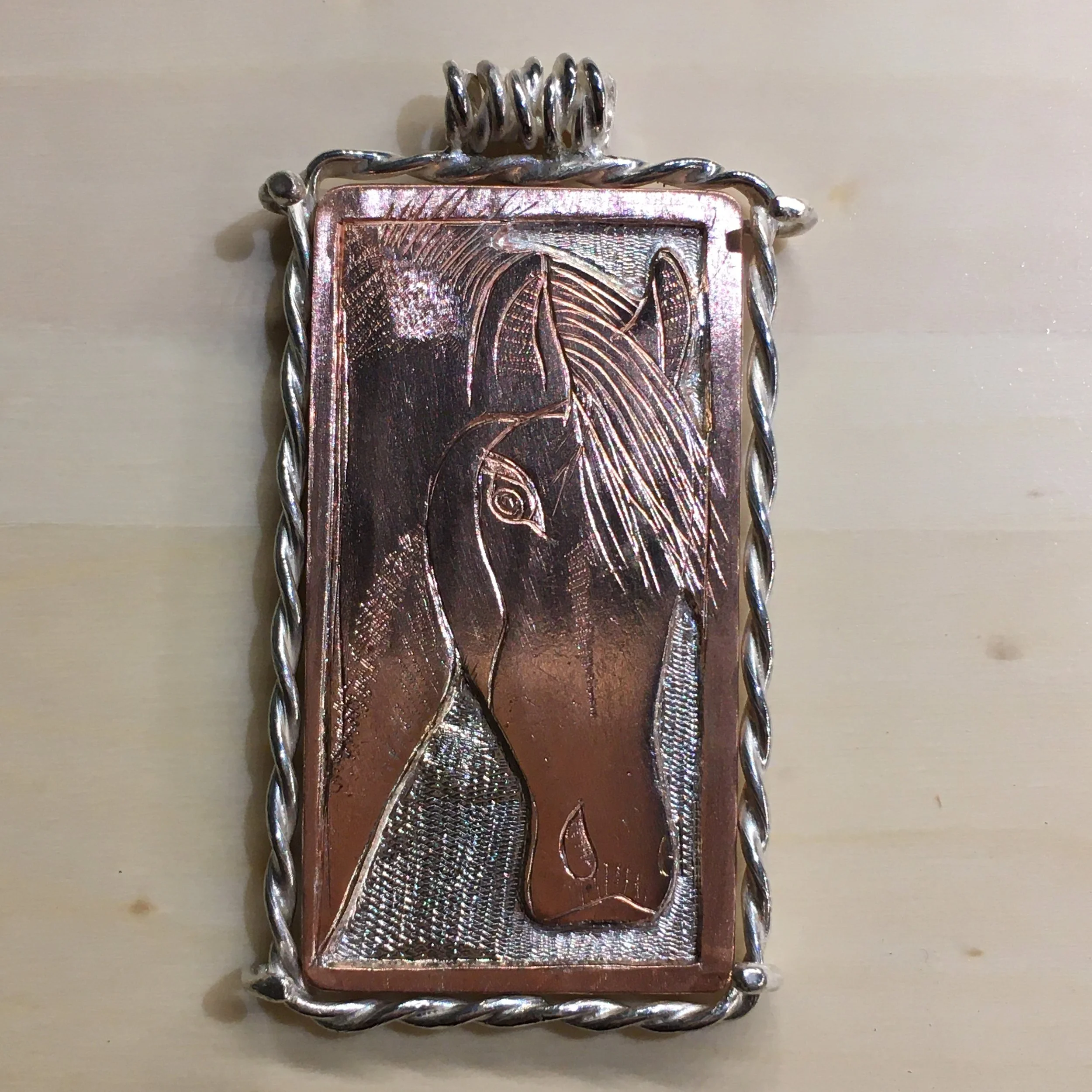 Engraved horse pendant