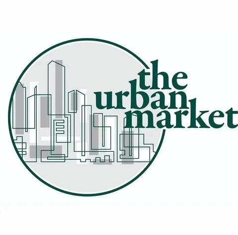 Logo for The Urban Market featuring a circle with city buildings outline and the text 'the urban market' inside.