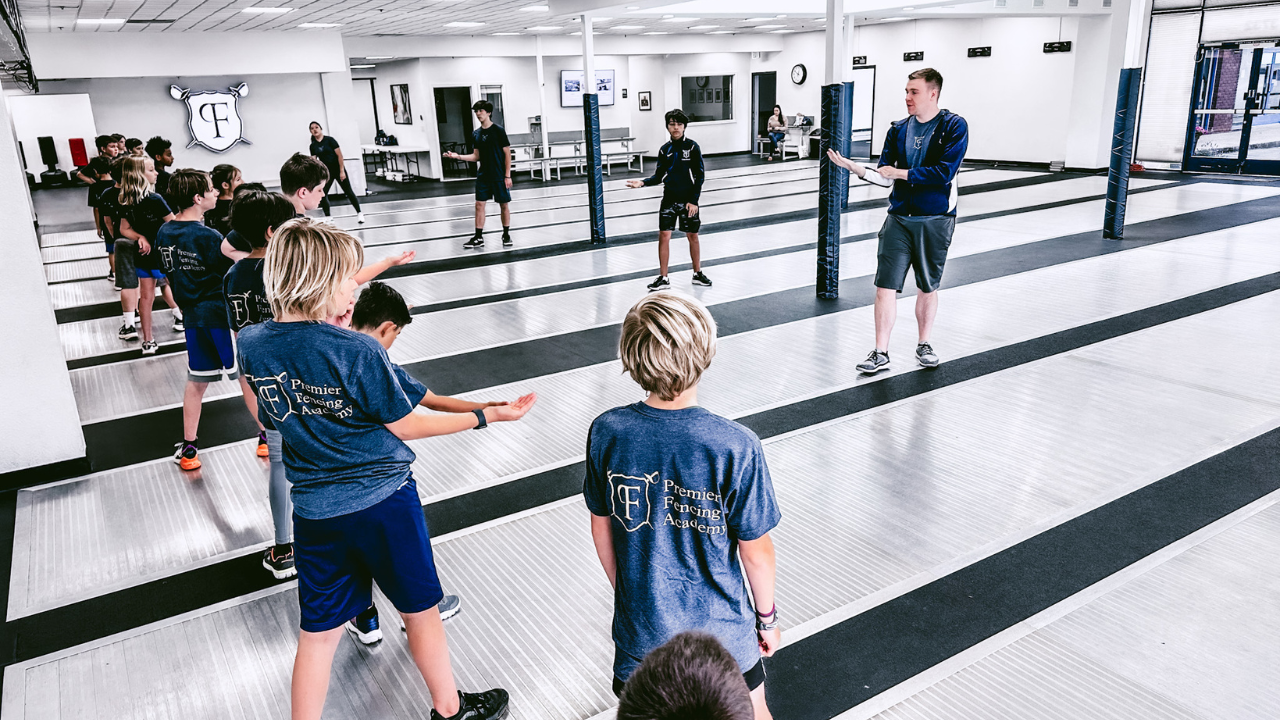 Young fencers practice footwork with a coach at Premier Fencing Academy in Sacramento.