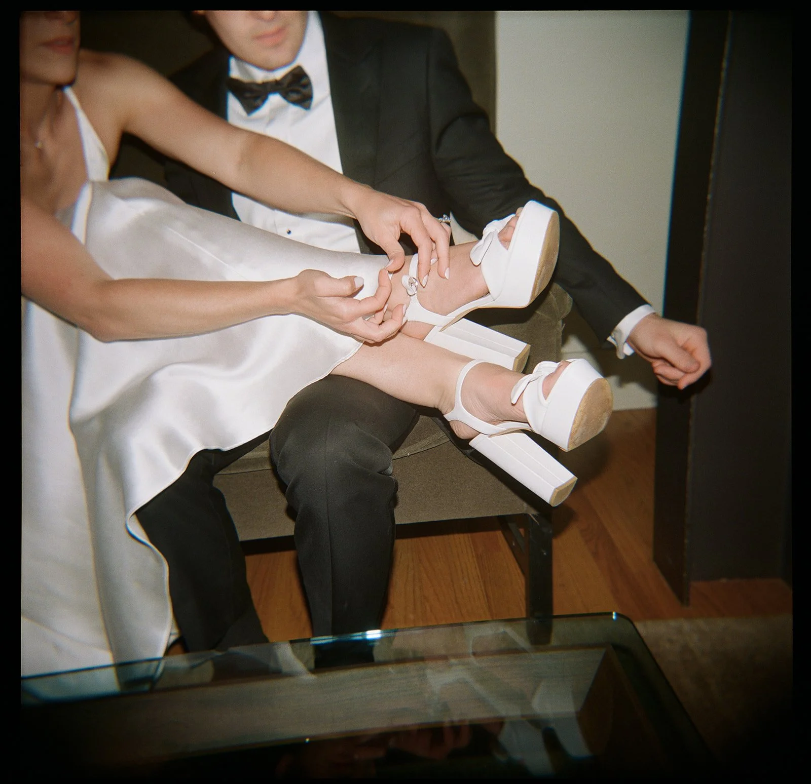 Bride putting on stylish wedding shoes