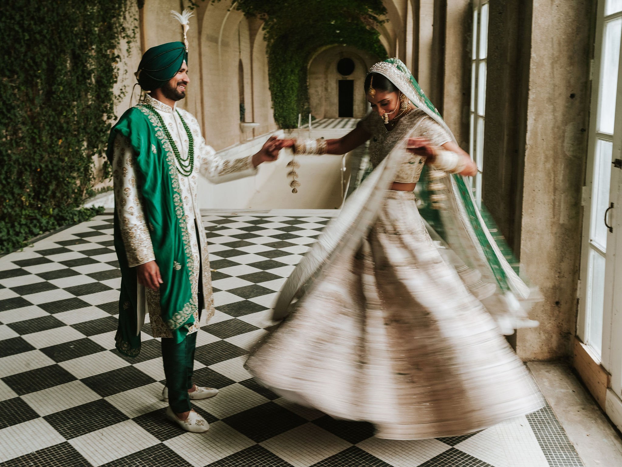 Bride and groom pictures at Oheka Castle, with checkerboard floor and ivy covered walls