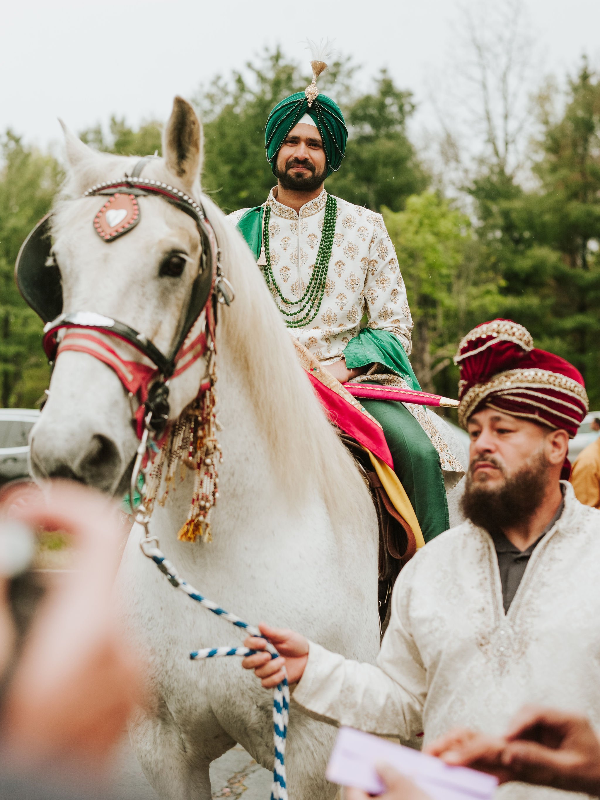 Groom entering on a horse for his Baraat