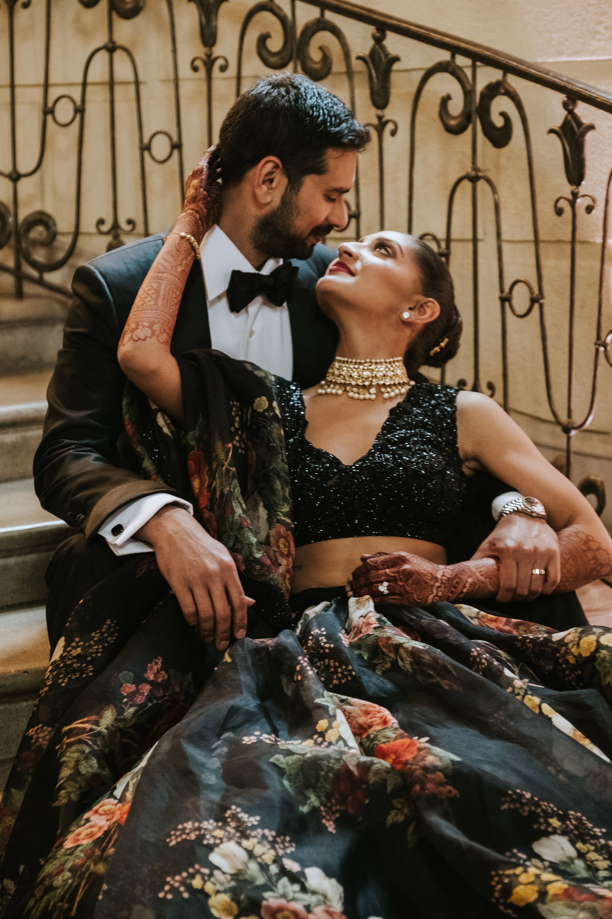 Bride and groom pictures at Oheka Castle on the staircase, wearing all black attire