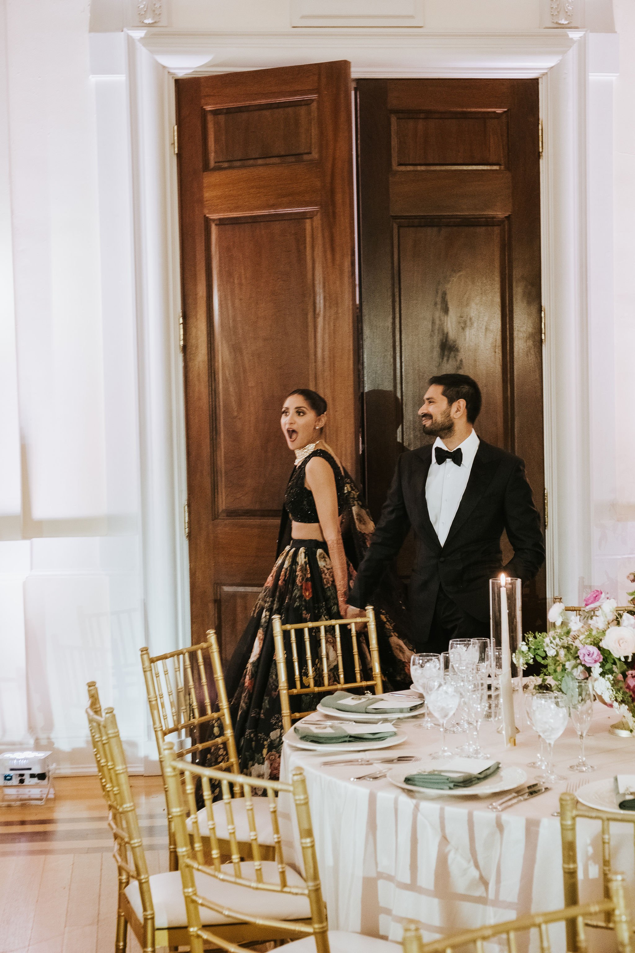 Bride and groom entering their wedding reception