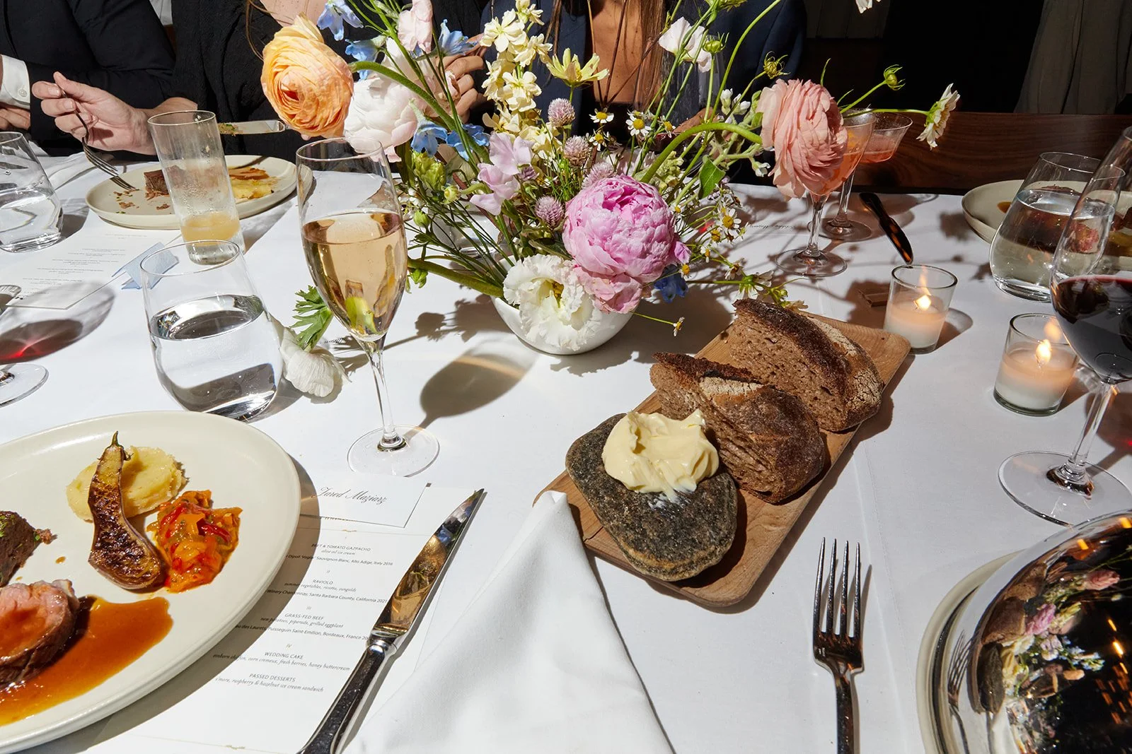 Elegant and intimate wedding dining setup with lush floral arrangements