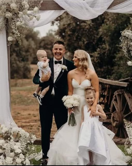 Keely and Ben with their children on their wedding day