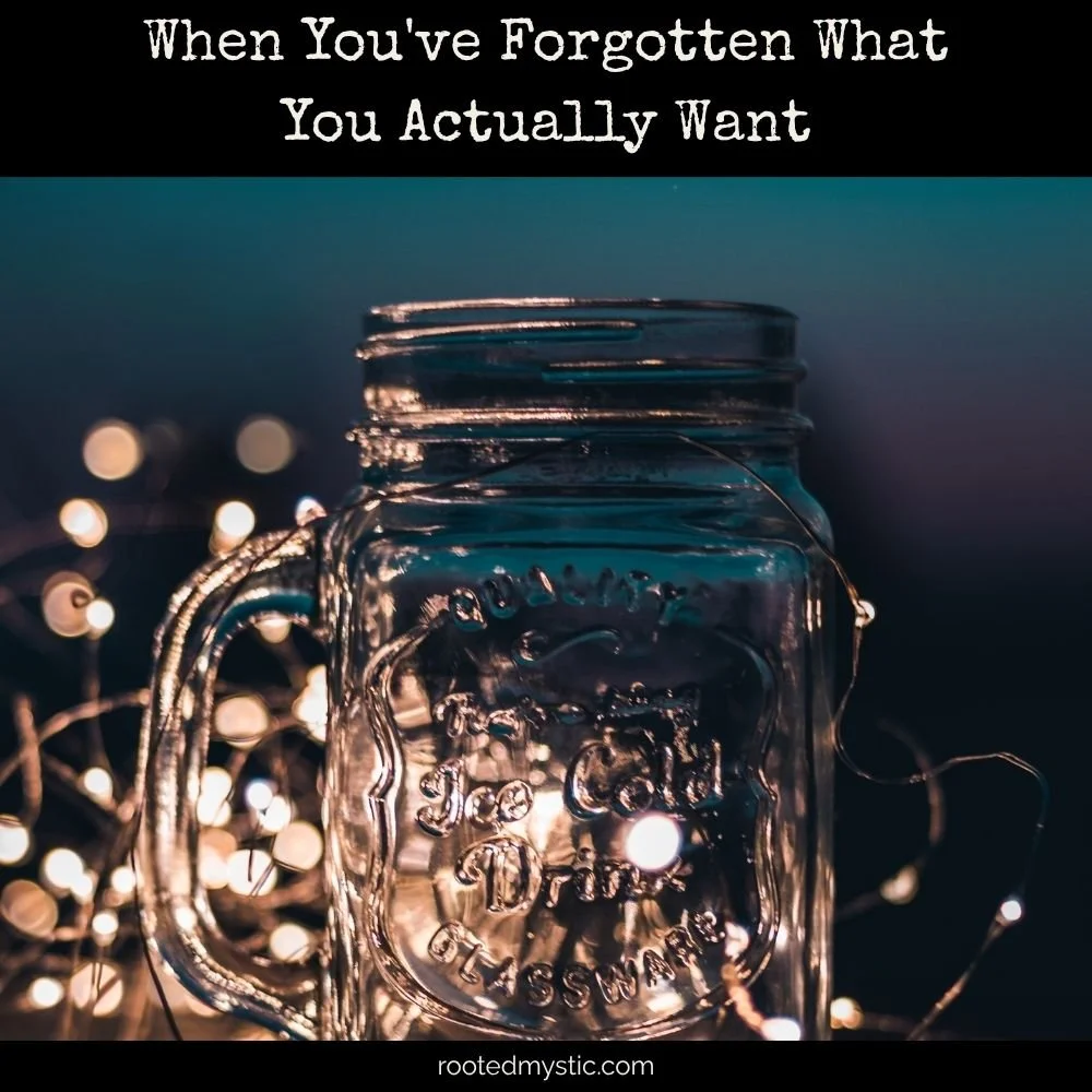 Empty mason jar with fairy lights surrounding, and teal + purple background
