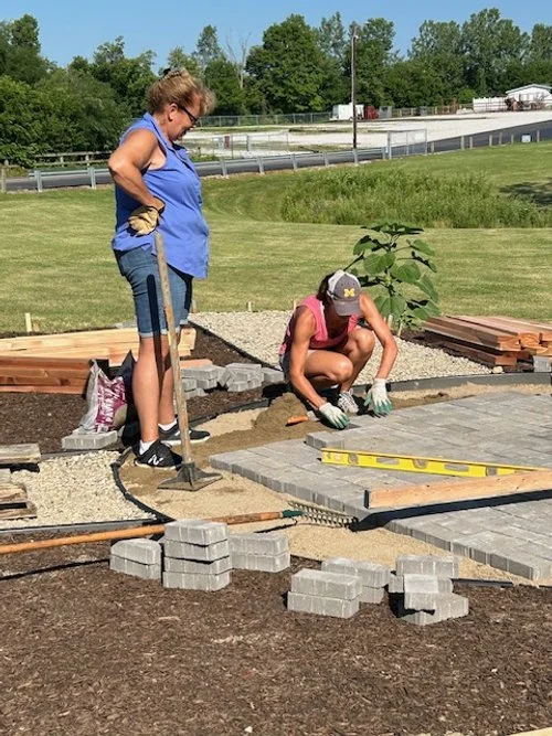 Adding the pavers for construction of the pergola.