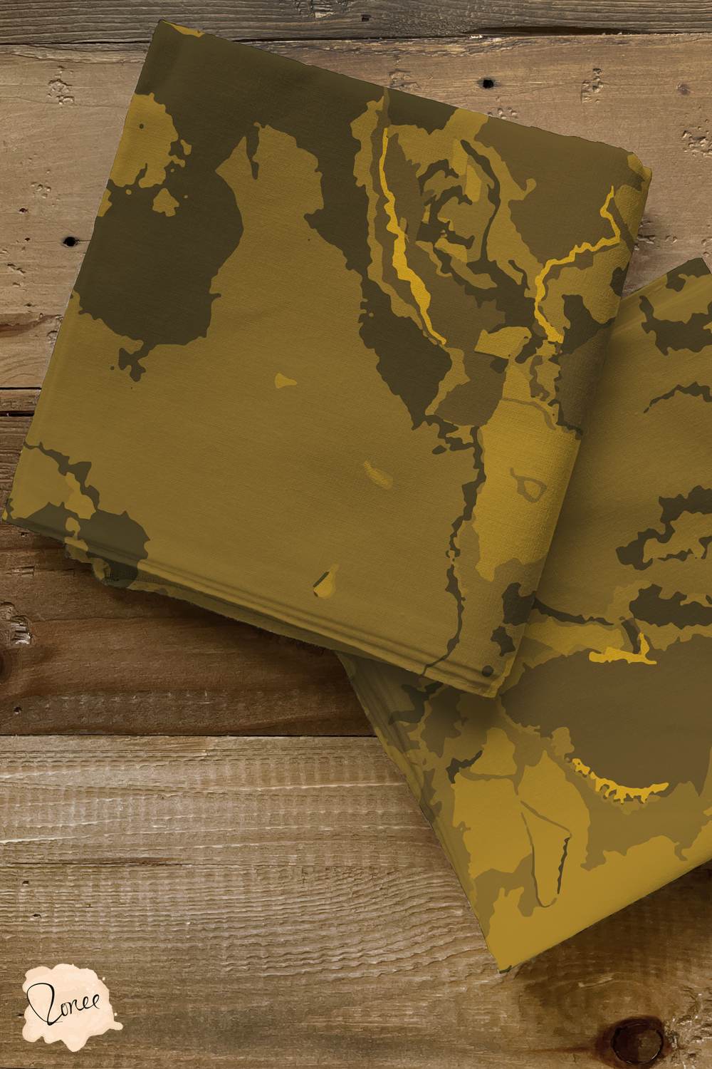 Dark golden brown modern abstract textured quilting fabric folded into two small squares, on a reclaimed wood surface.