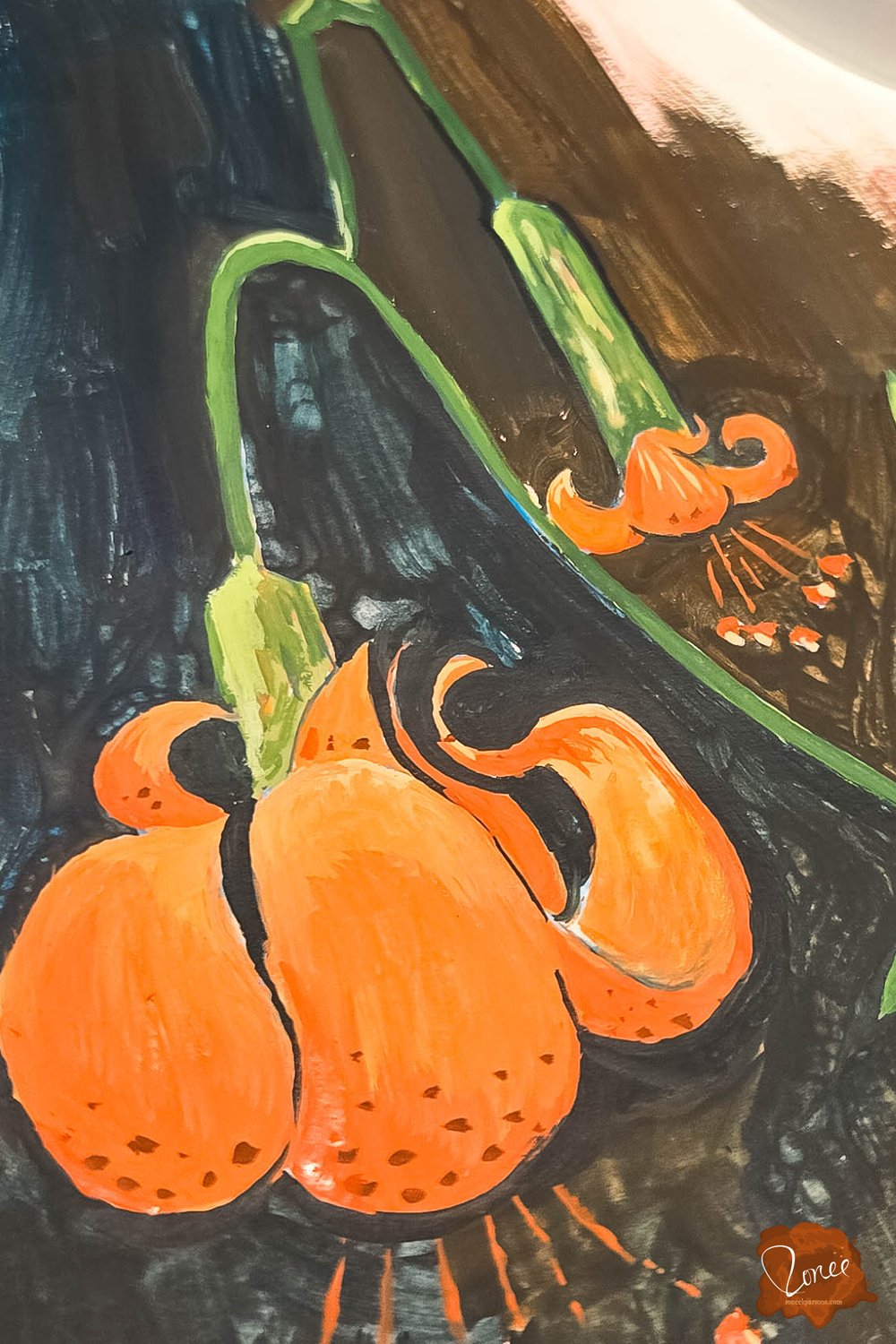 Close up flat lay image of a sketchbook with a gouache lily painting.