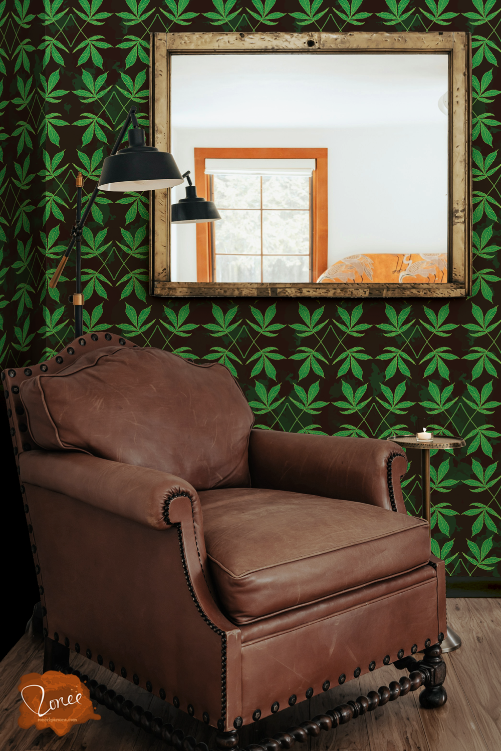 Old leather chair with a black floor lamp and vintage mirror in a room with black wallpaper with a pattern of cannabis leaves.