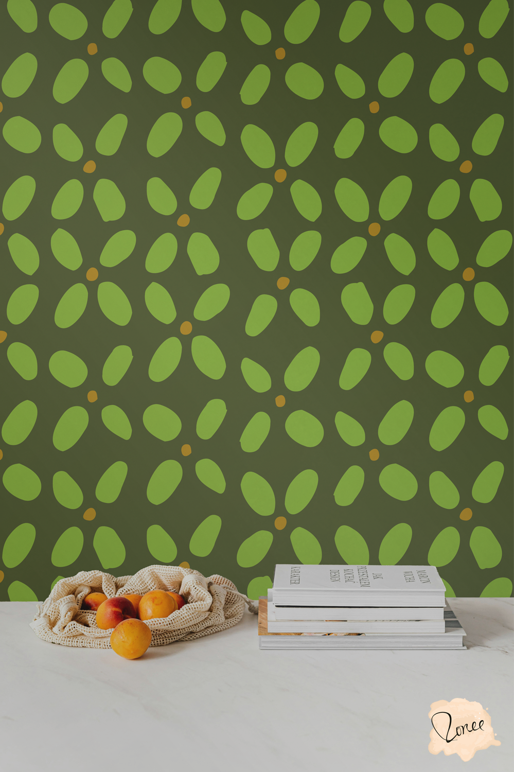 Vintage green jumbo abstract geometric wallpaper behind a white kitchen counter with a mesh bag spilling oranges and a stack of cookbooks.
