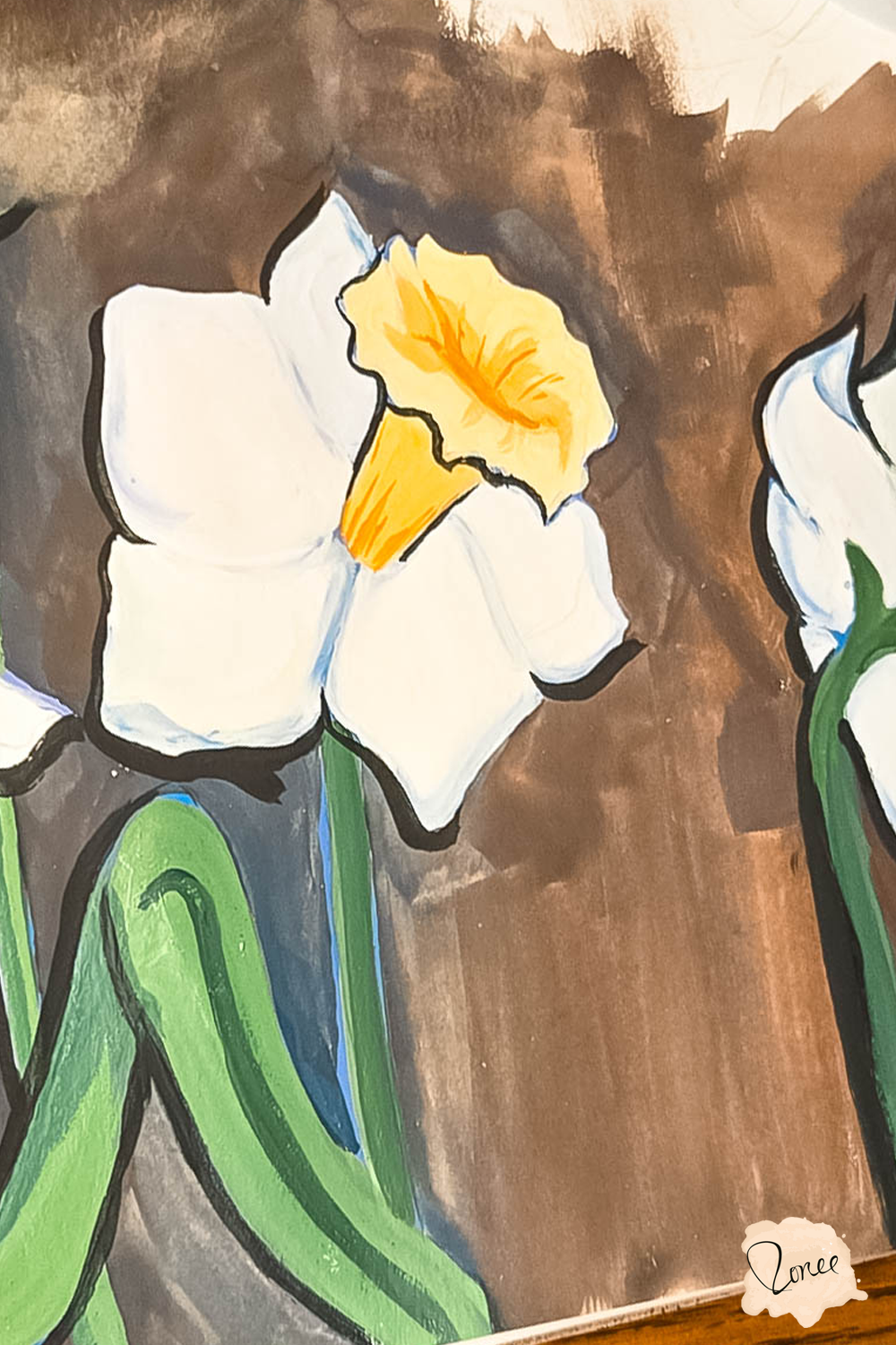 Close up flat lay image of a sketchbook with a gouache daffodil painting.