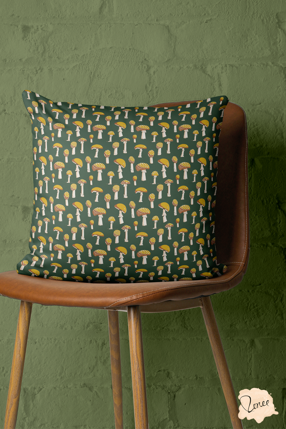 Retro yellow mushrooms on dark green throw pillow on a vintage wooden chair with a painted brick wall behind.