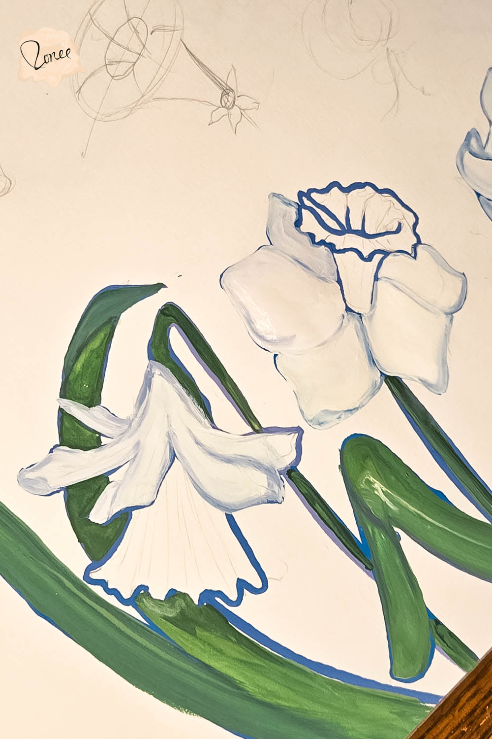 Close up flat lay image of a sketchbook with a gouache daffodils painting in progress.