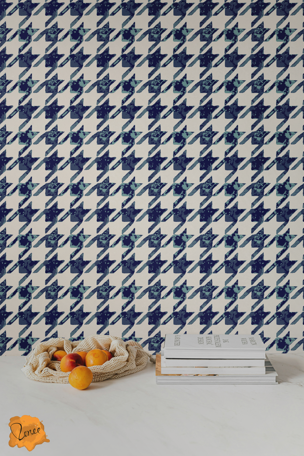 Blue and white textured hounds tooth wallpaper behind kitchen counter with oranges spilling out of a cloth bag.