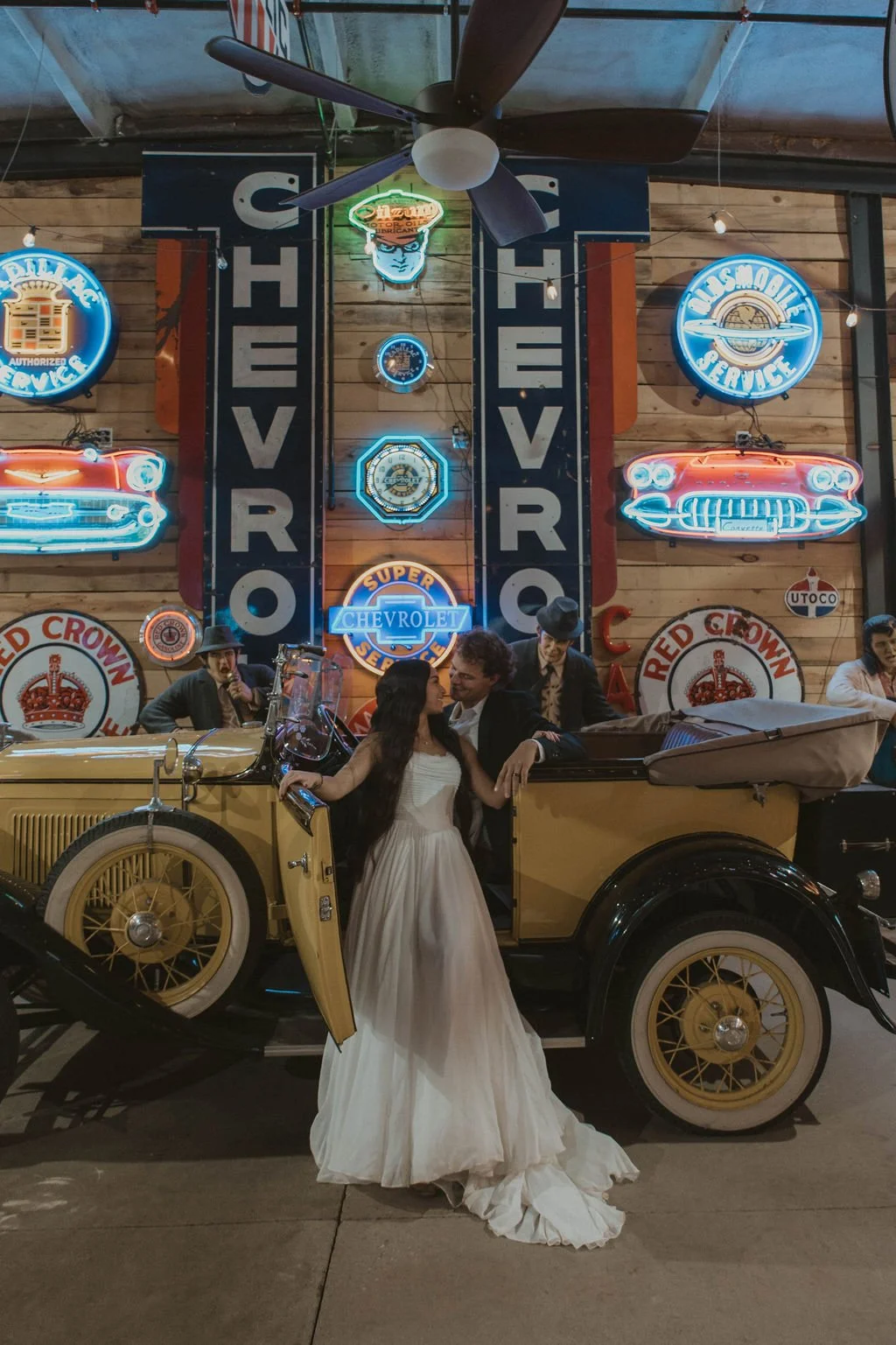 A couple and a vintage model A inside Sparks Museum.