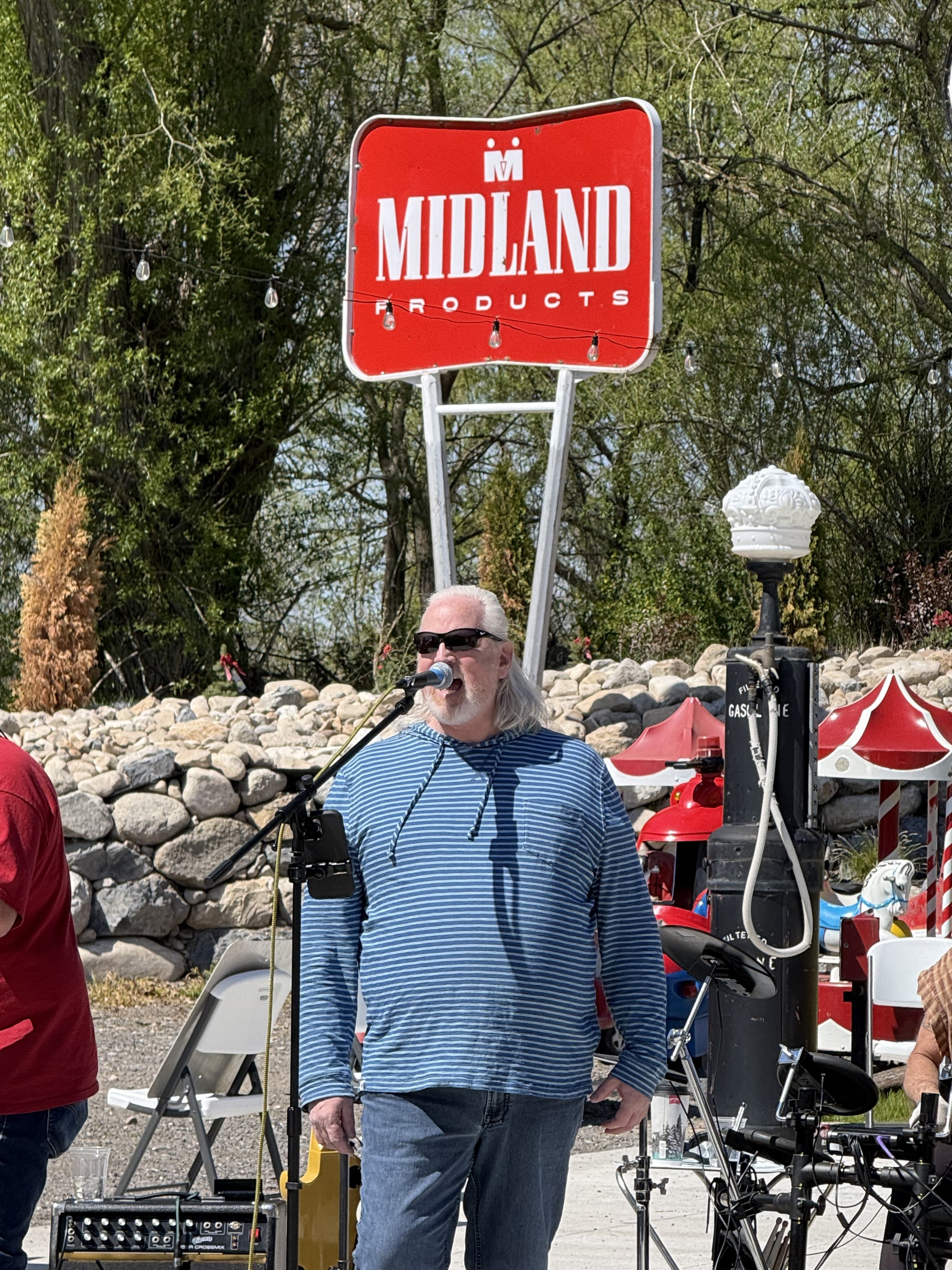 Guests sharing tributes with a wireless microphone at an accessible memorial venue in Utah County