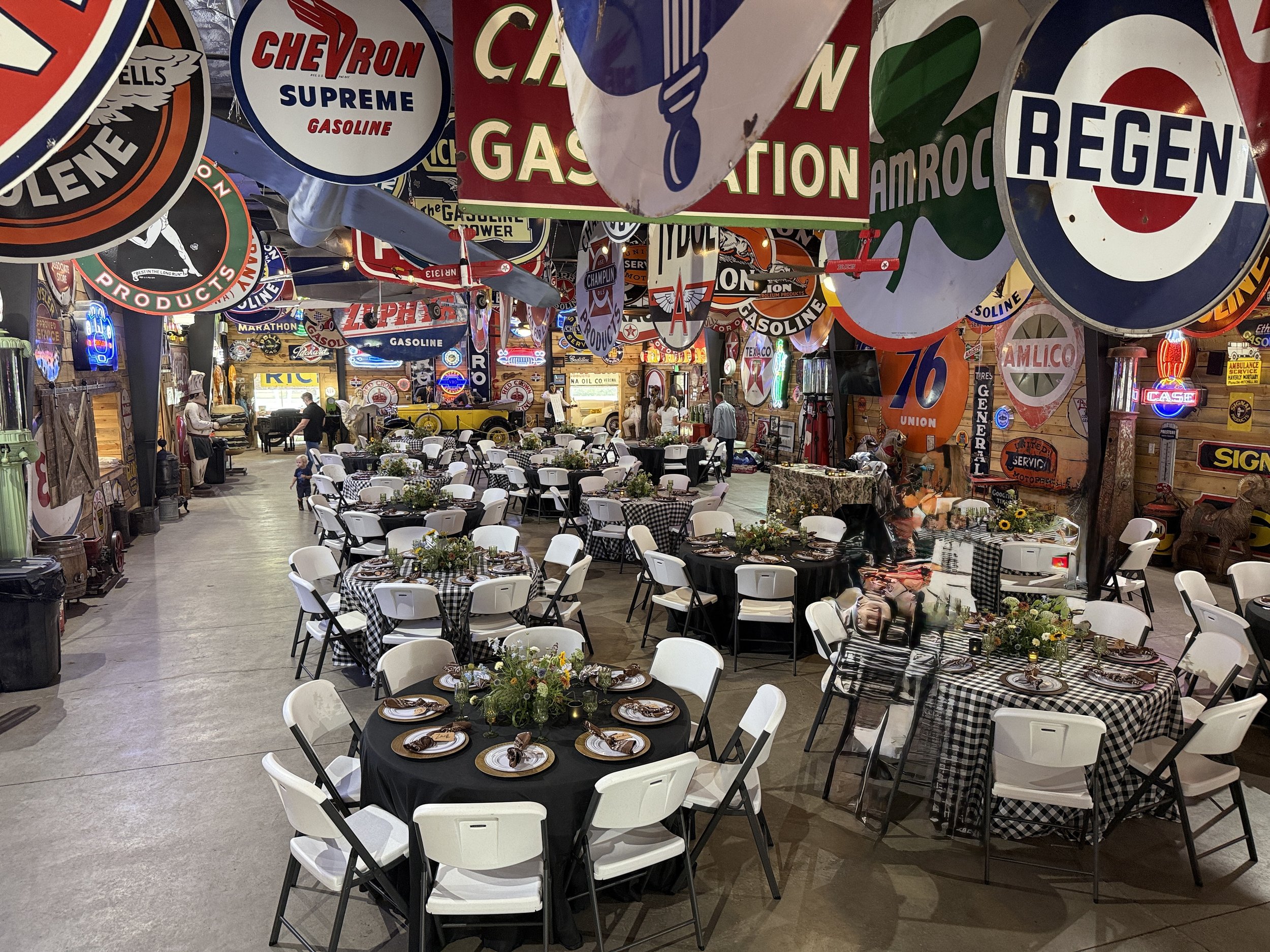 Unique Orem-area adult birthday party venue with antique gas pumps, neon signs, and classic car displays