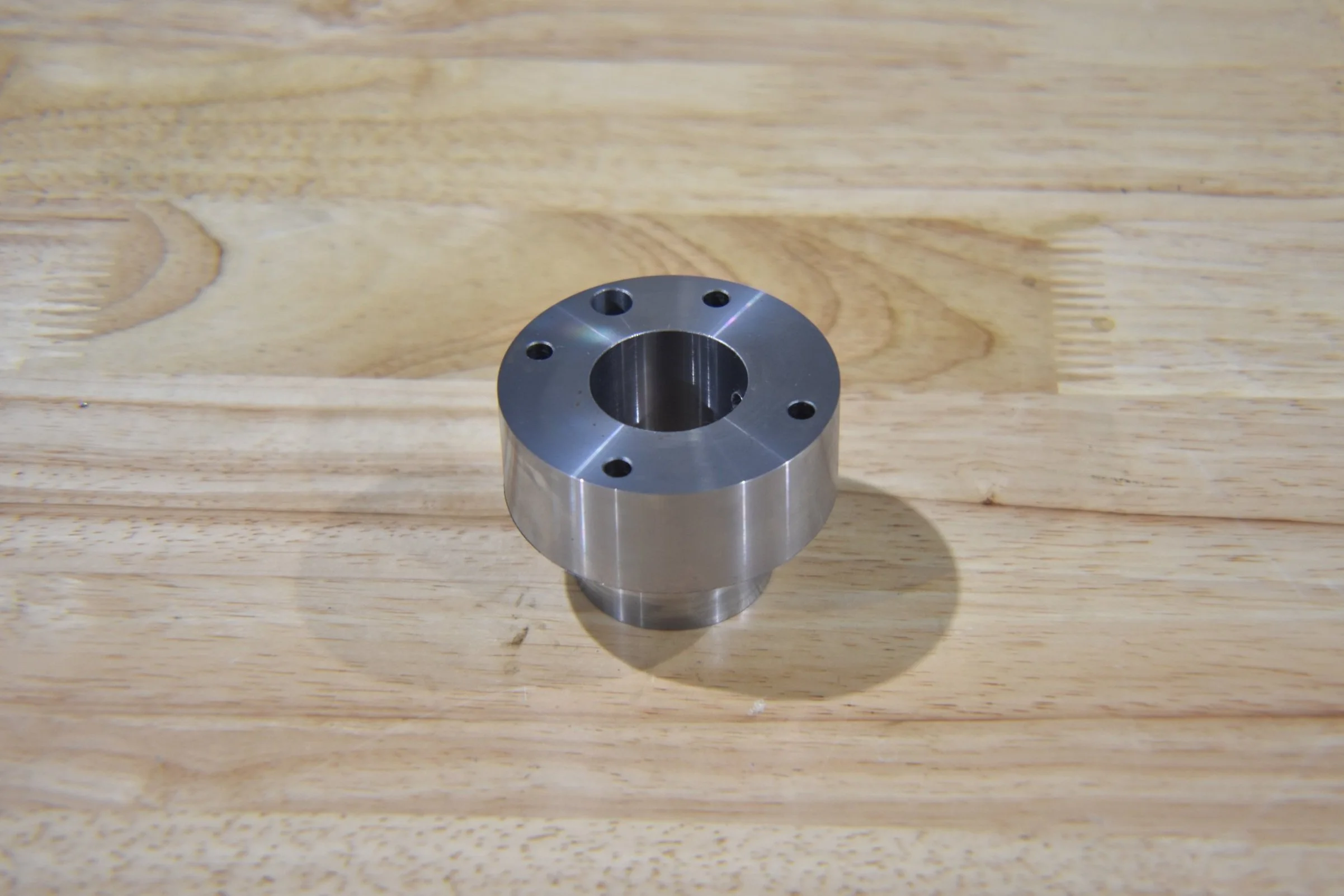 Metal mechanical part with a central hole.