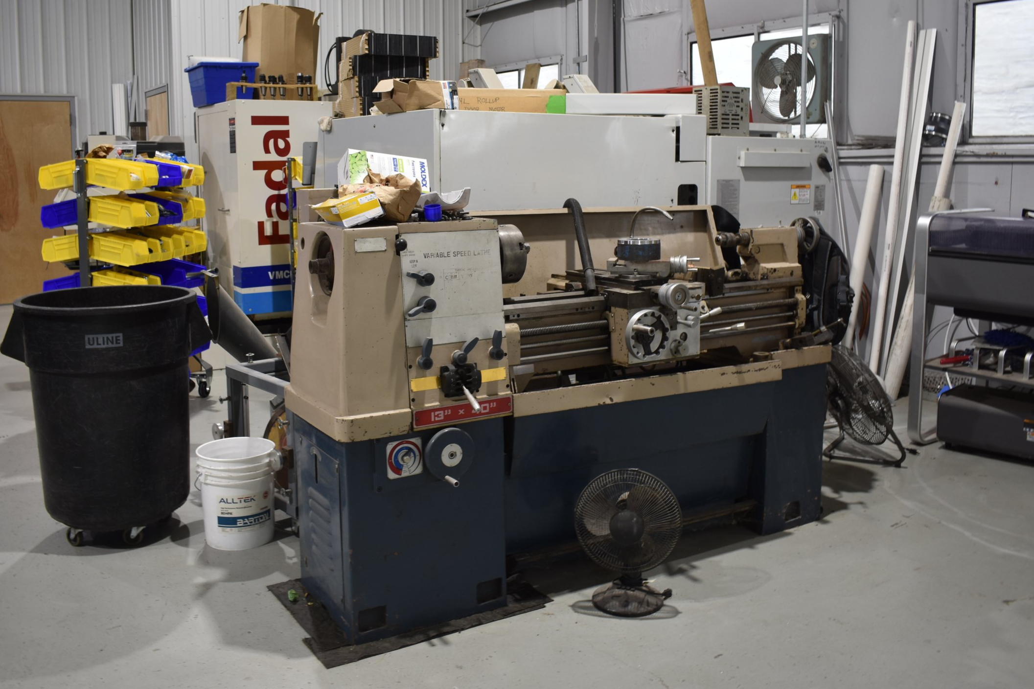 A workshop with a large industrial lathe machine.