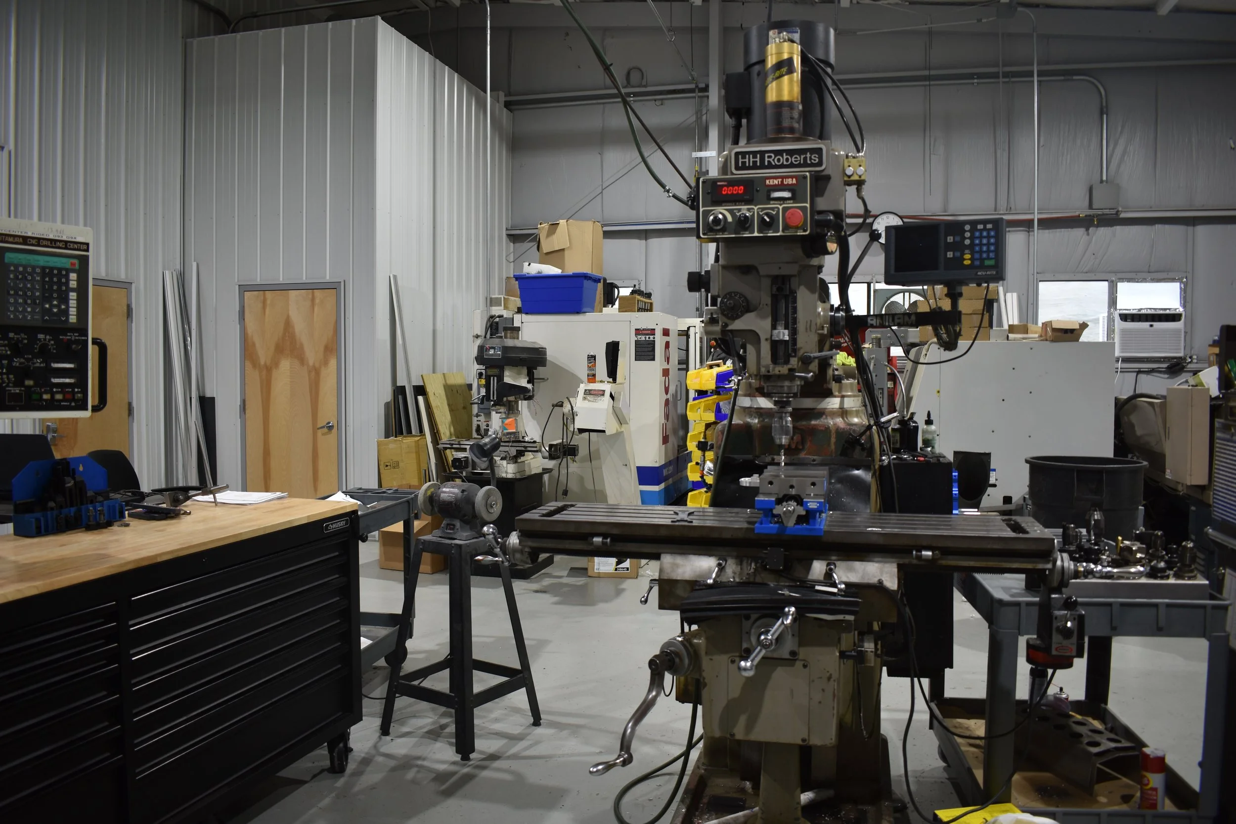 An industrial workshop with a large CNC milling machine.
