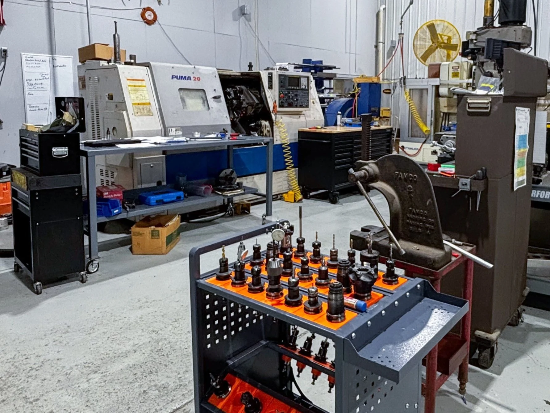 A workshop with machining tools and equipment, including a Puma 20, etc.