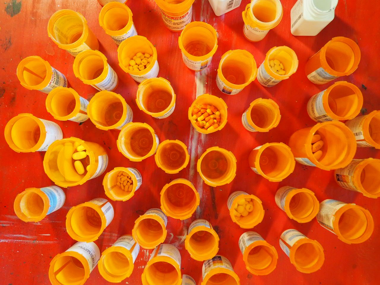 open leftover orange bottle pills, personal expired medication from decades of medical and psychiatric treatment