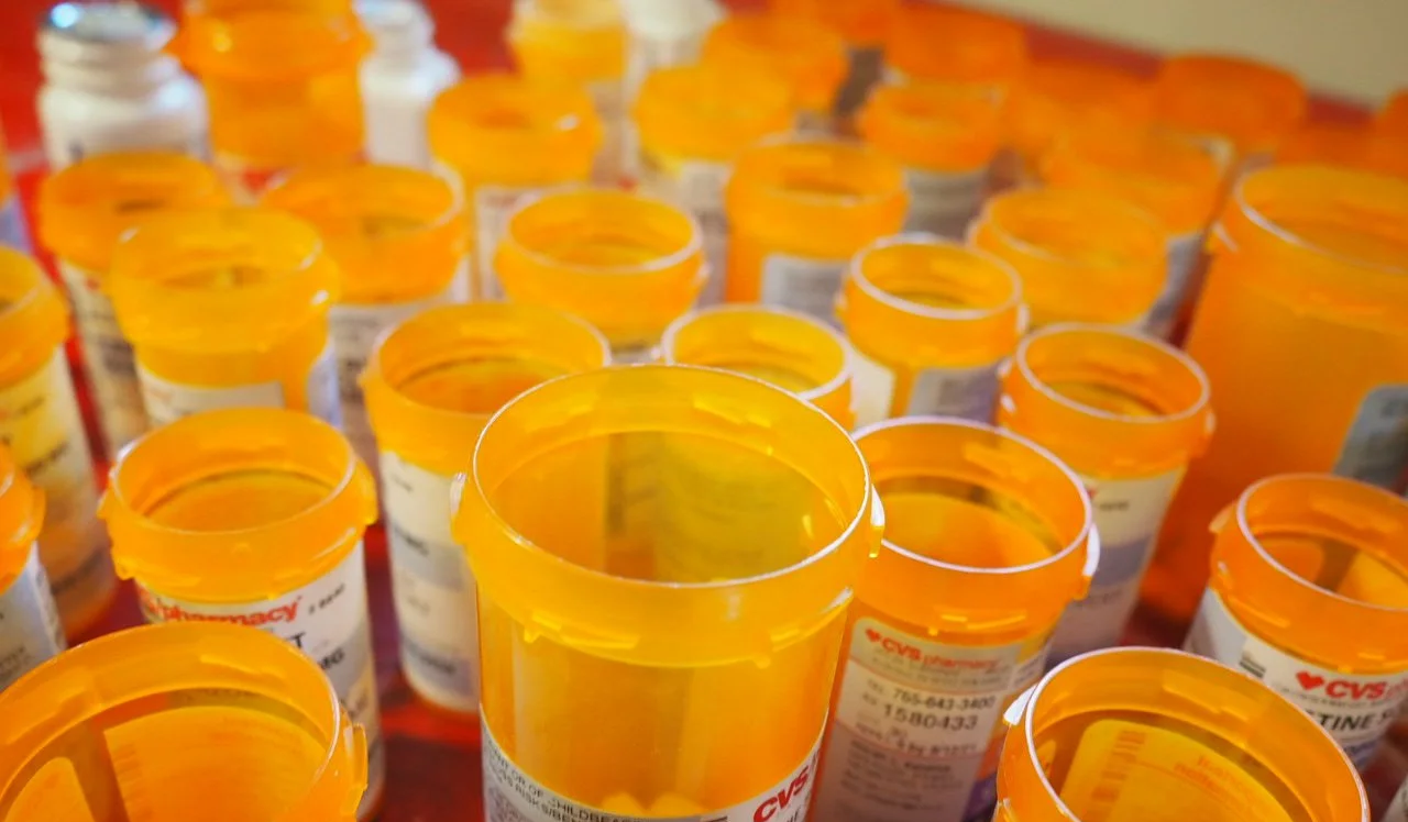 the orange tops of familiar cvs pill bottles, some leftover medication