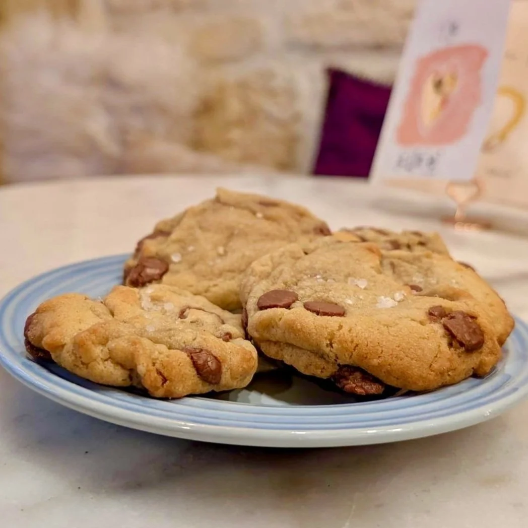 Plate of chocolate chip cookies on a table.