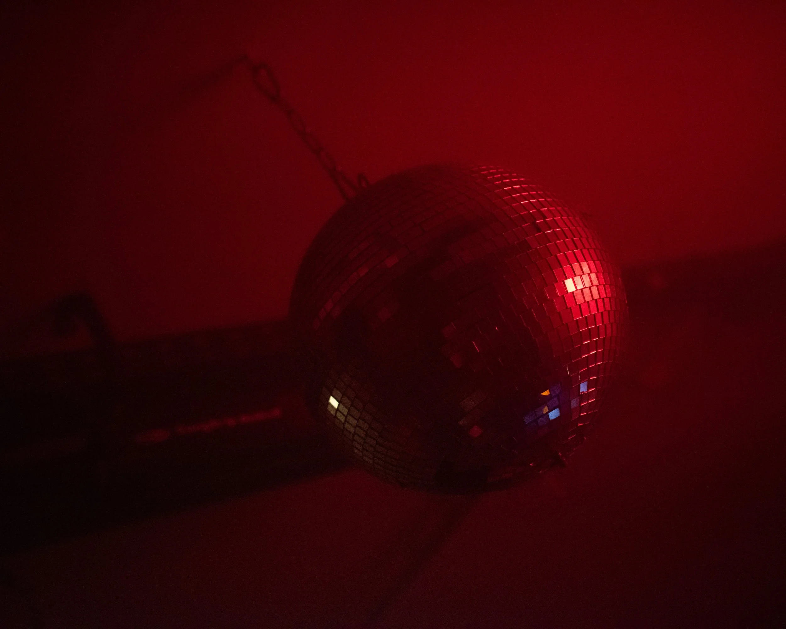 Disco ball illuminated by red light