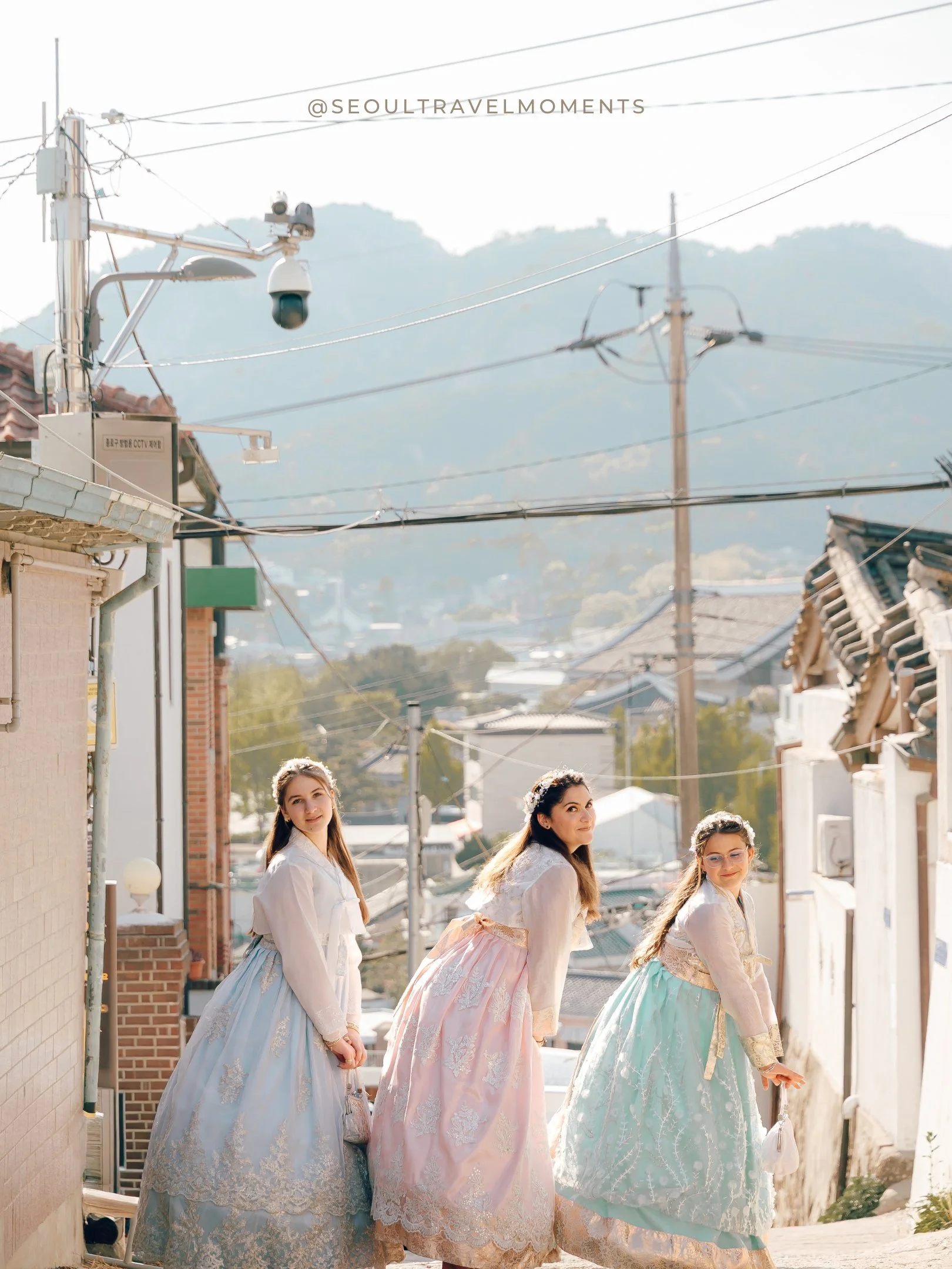 Family photoshoot in Seoul with a mother holding hands with her children in hanbok