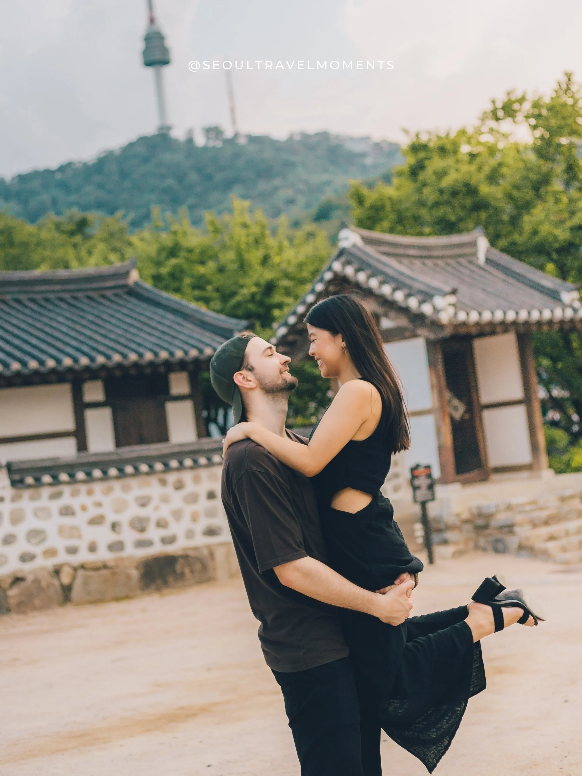 Engagement photography at Namsangol Hanok Village in Seoul, featuring a couple celebrating their proposal in a historic Korean courtyard.