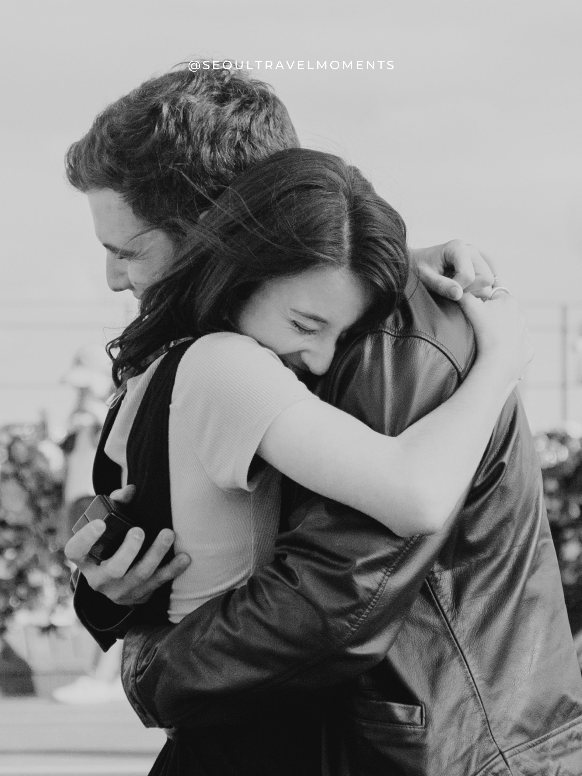 Engagement photography near Namsan Tower in Seoul, featuring a couple celebrating their proposal with iconic city views.