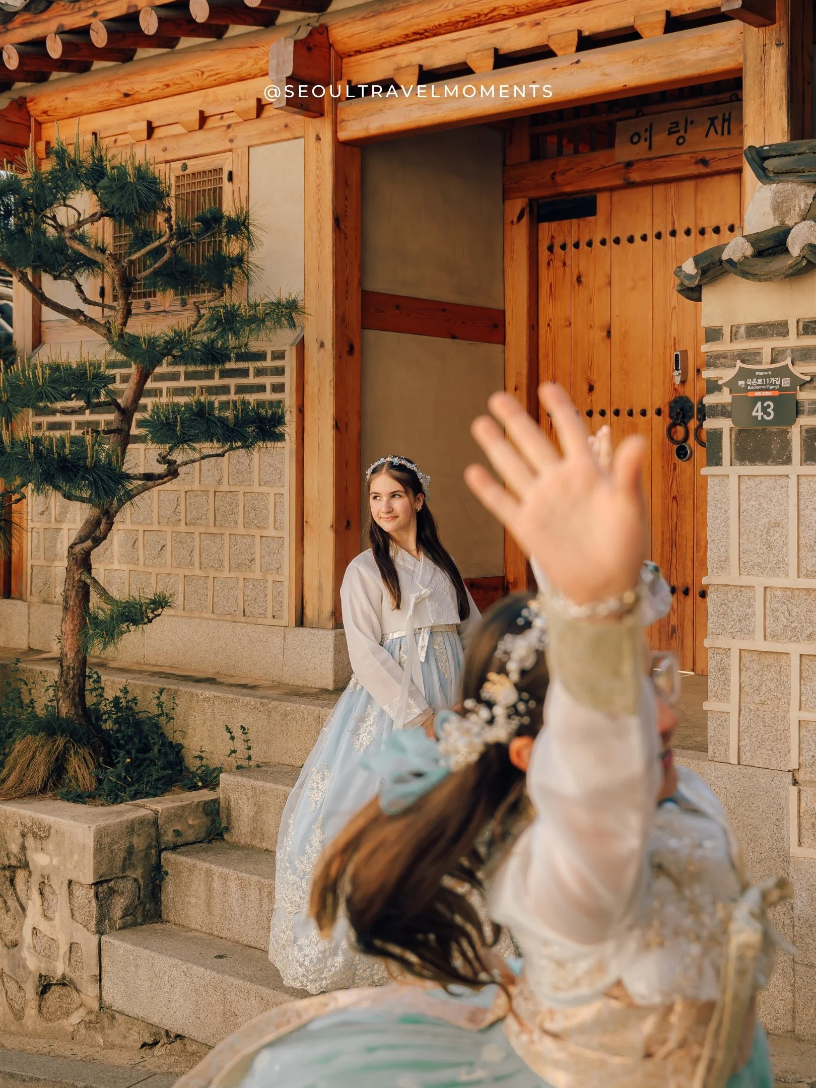 Close moment of a mother and daughters during a hanbok photoshoot in Bukchon Hanok Village