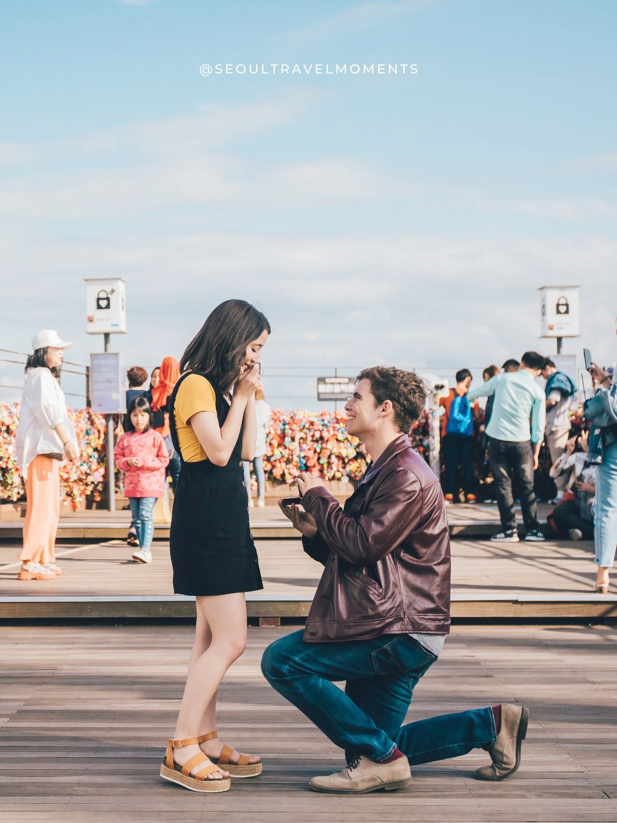Proposal photoshoot in Seoul with Namsan Tower in the background, capturing an emotional engagement moment overlooking the city.
